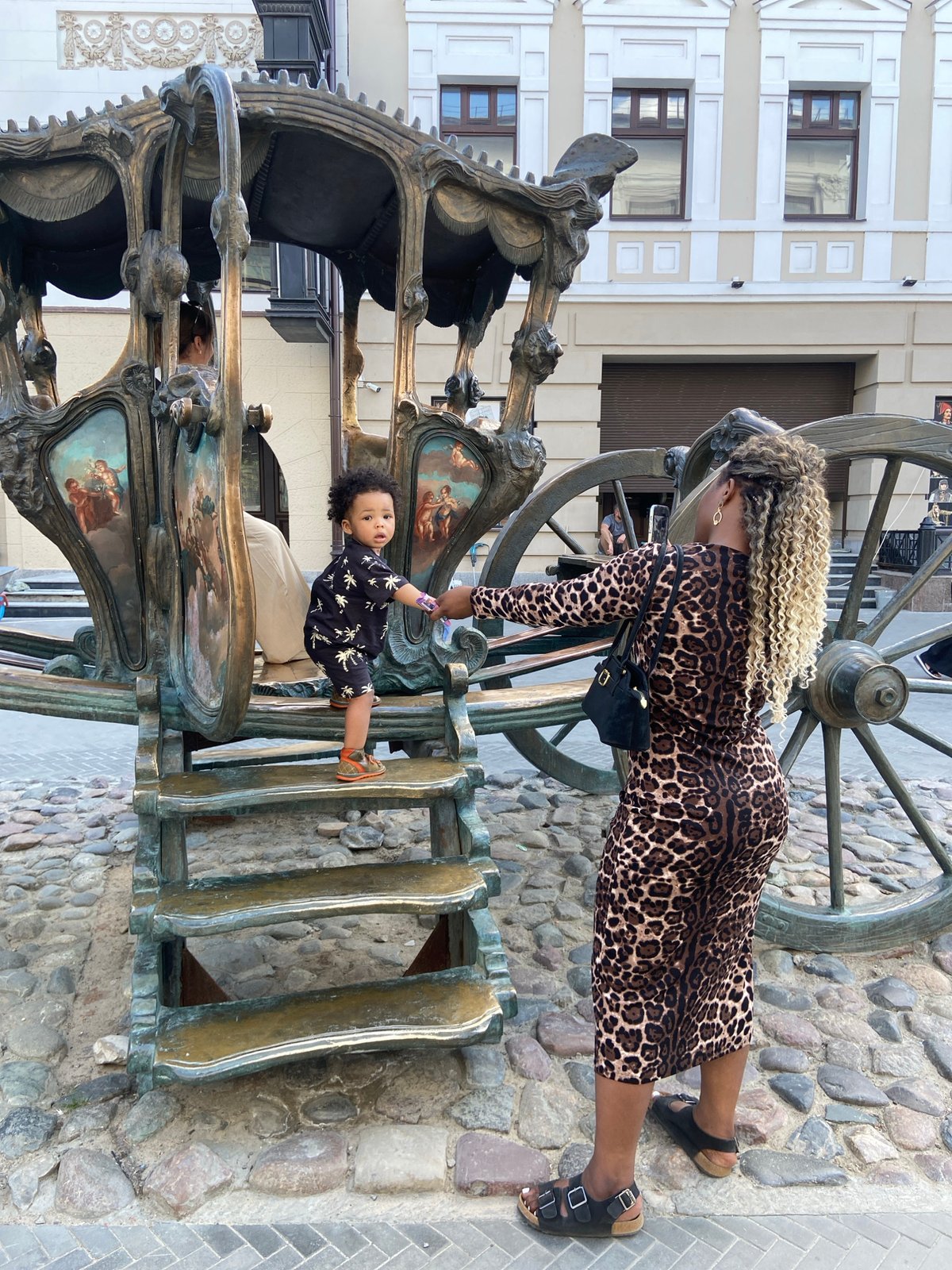 Mother and child explore public art sculptures in Kazan
