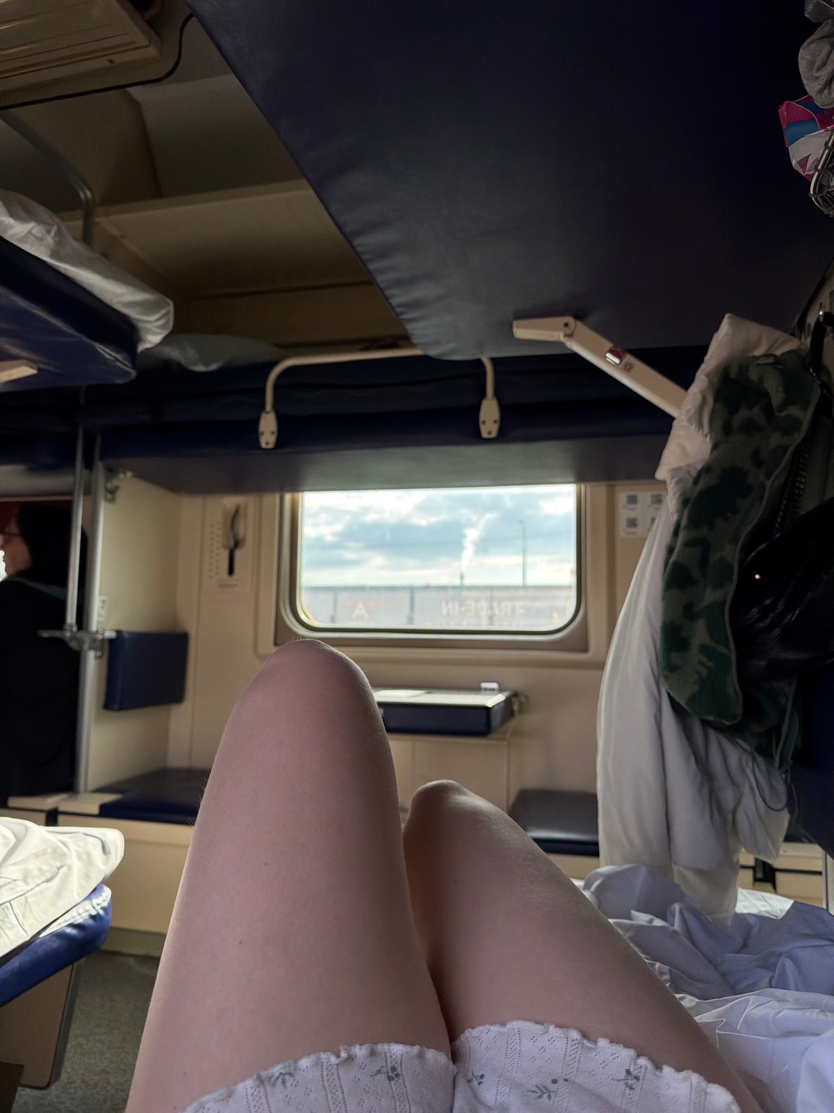 Train passenger rests in sleeper car passing through Krasnodar