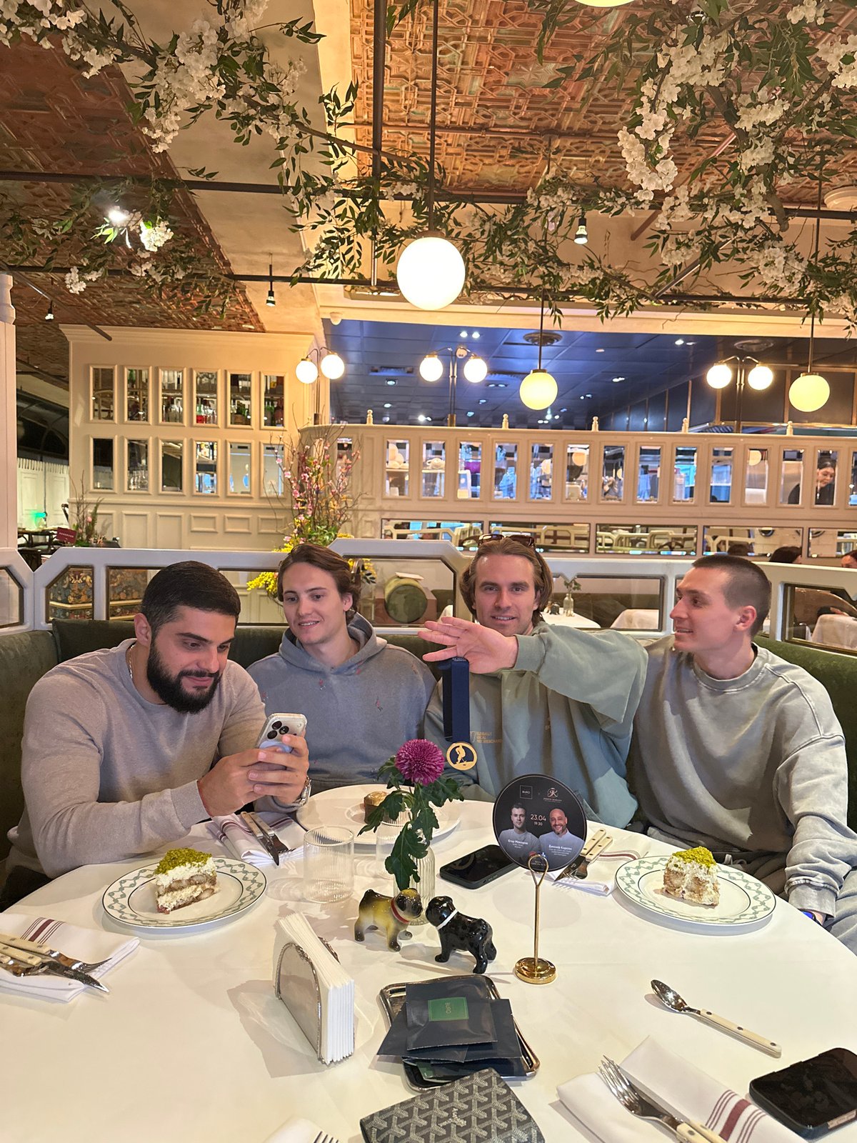 Four men celebrate with desserts at Moscow restaurant