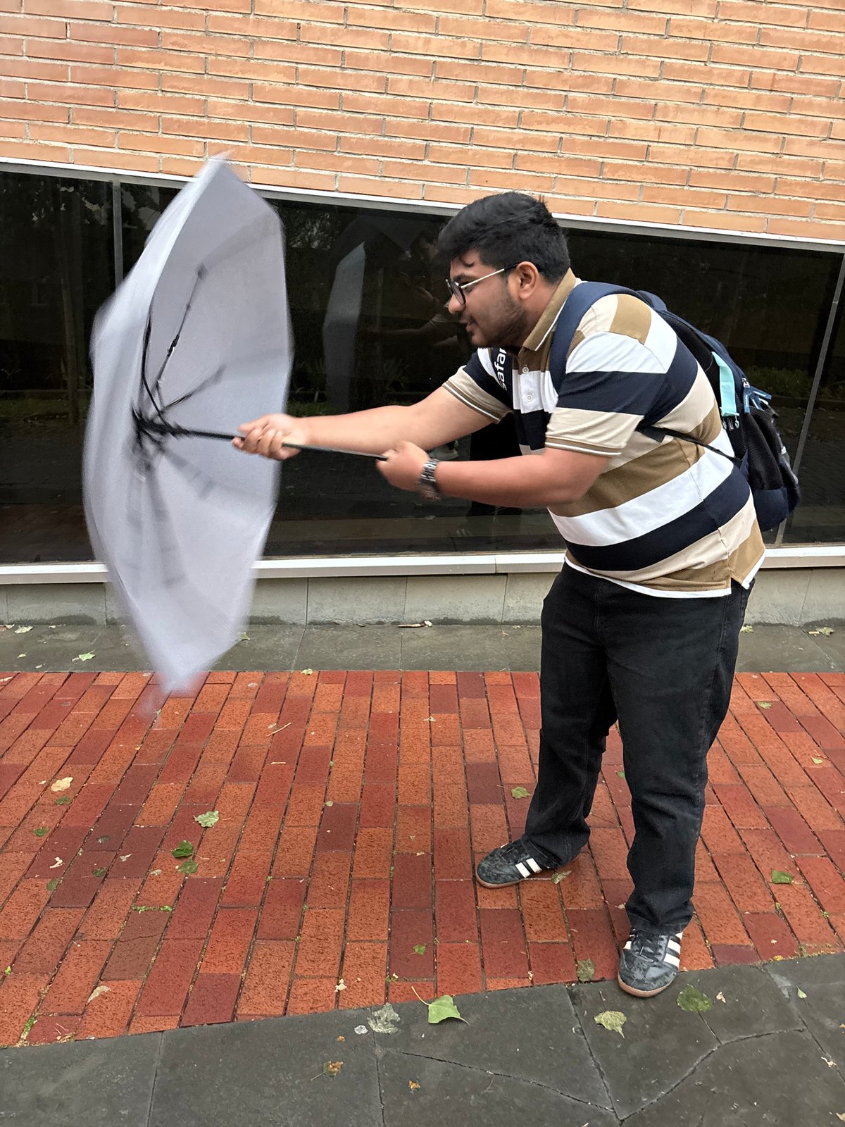 Barcelona residents weather windy rainstorm with umbrellas