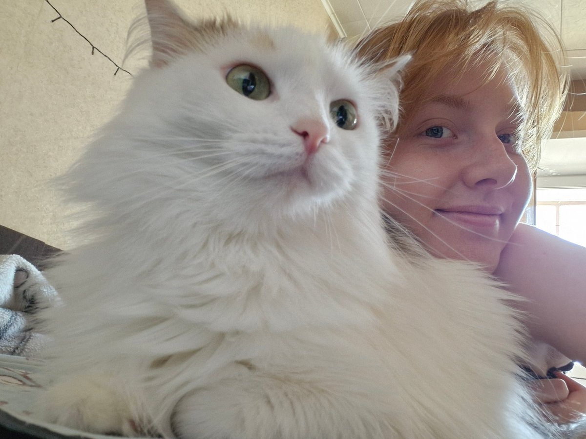 Woman poses with white cat in Yekaterinburg