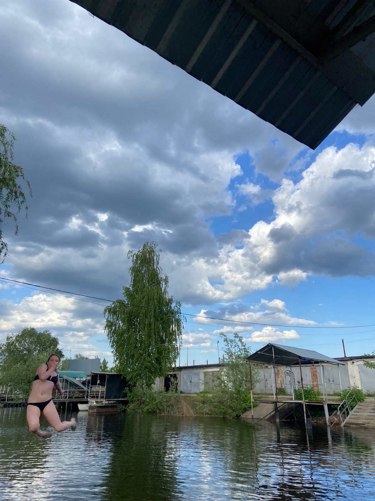 Woman swims with corgi dog in Chaikovsky waterway
