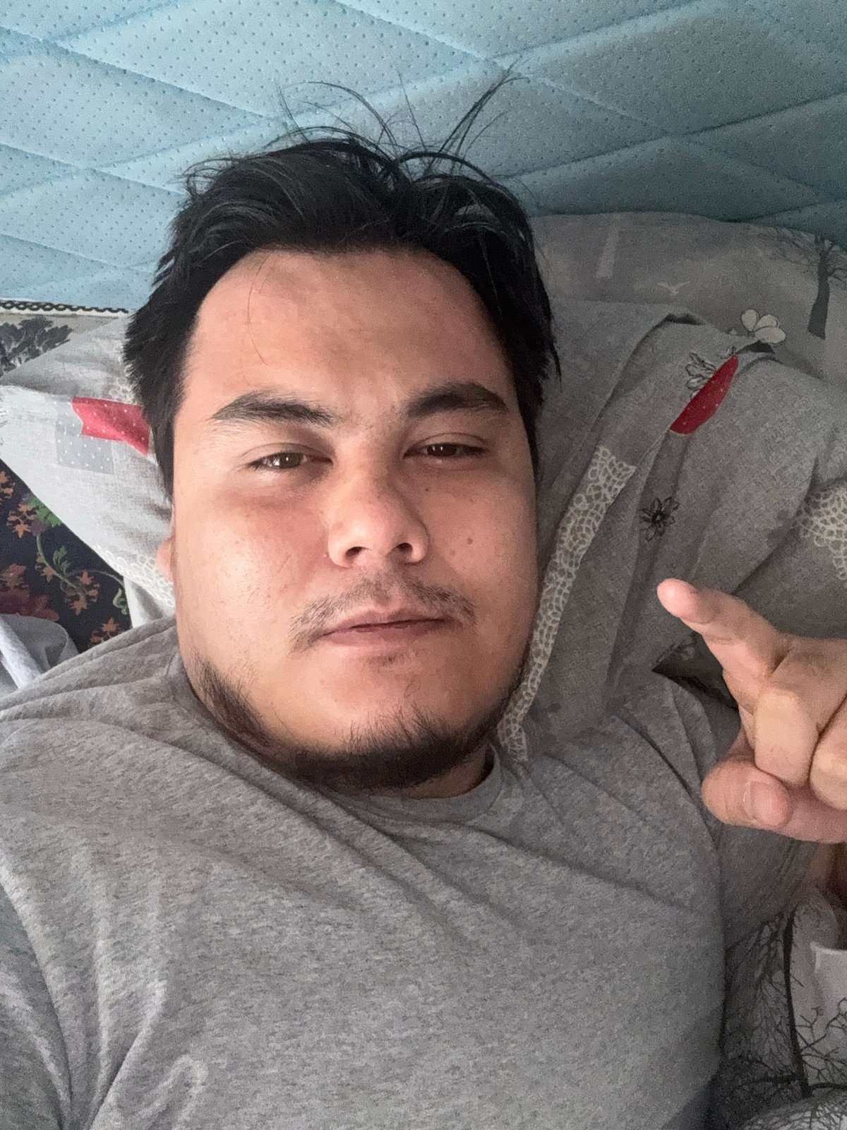 Casual indoor selfie from a bed in Chirchik, Uzbekistan
