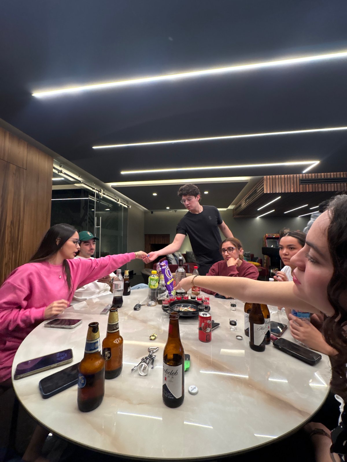 Young adults play drinking games at early morning gathering