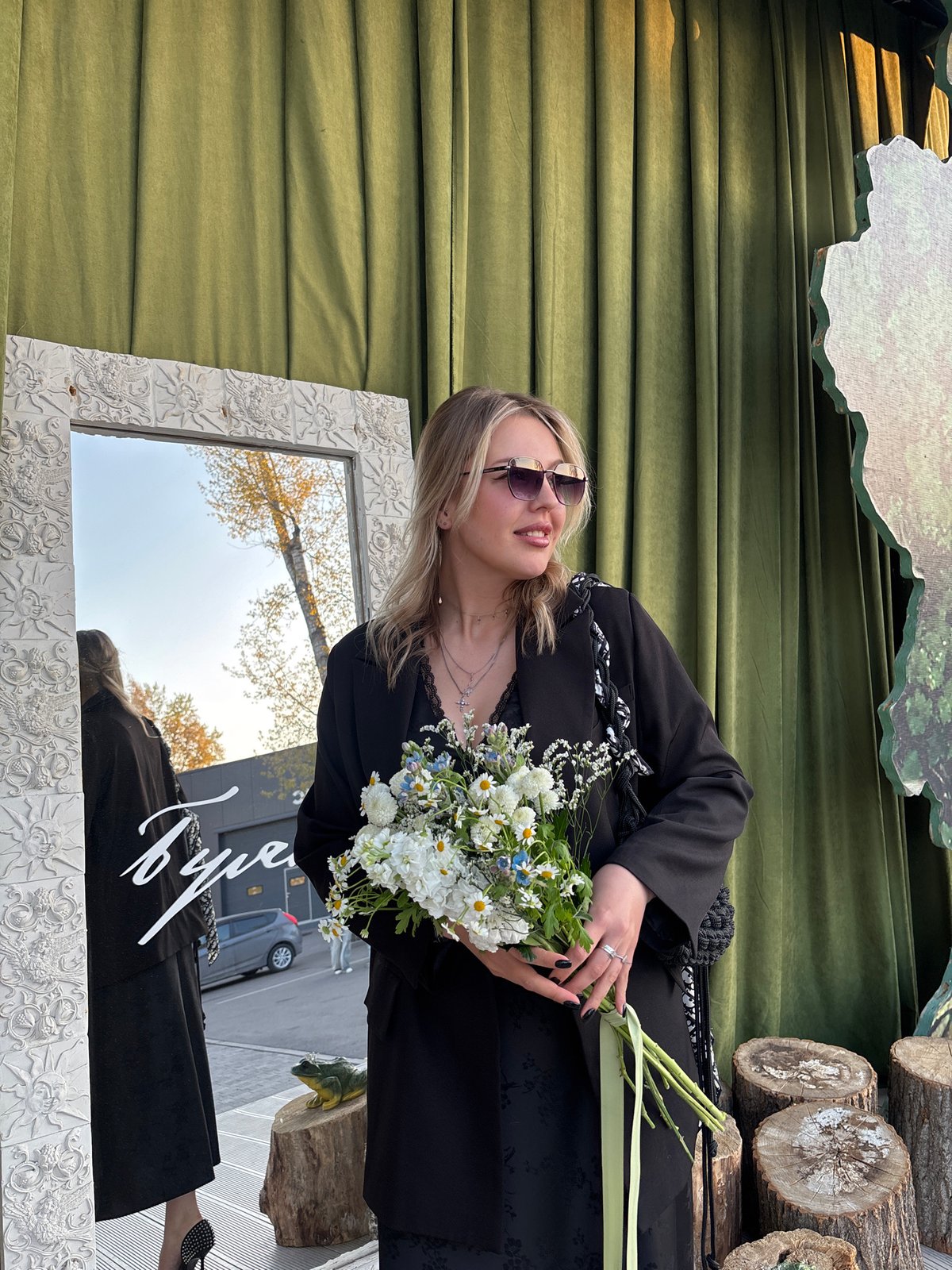Woman with bouquet photographed at mirror in Krasnoyarsk