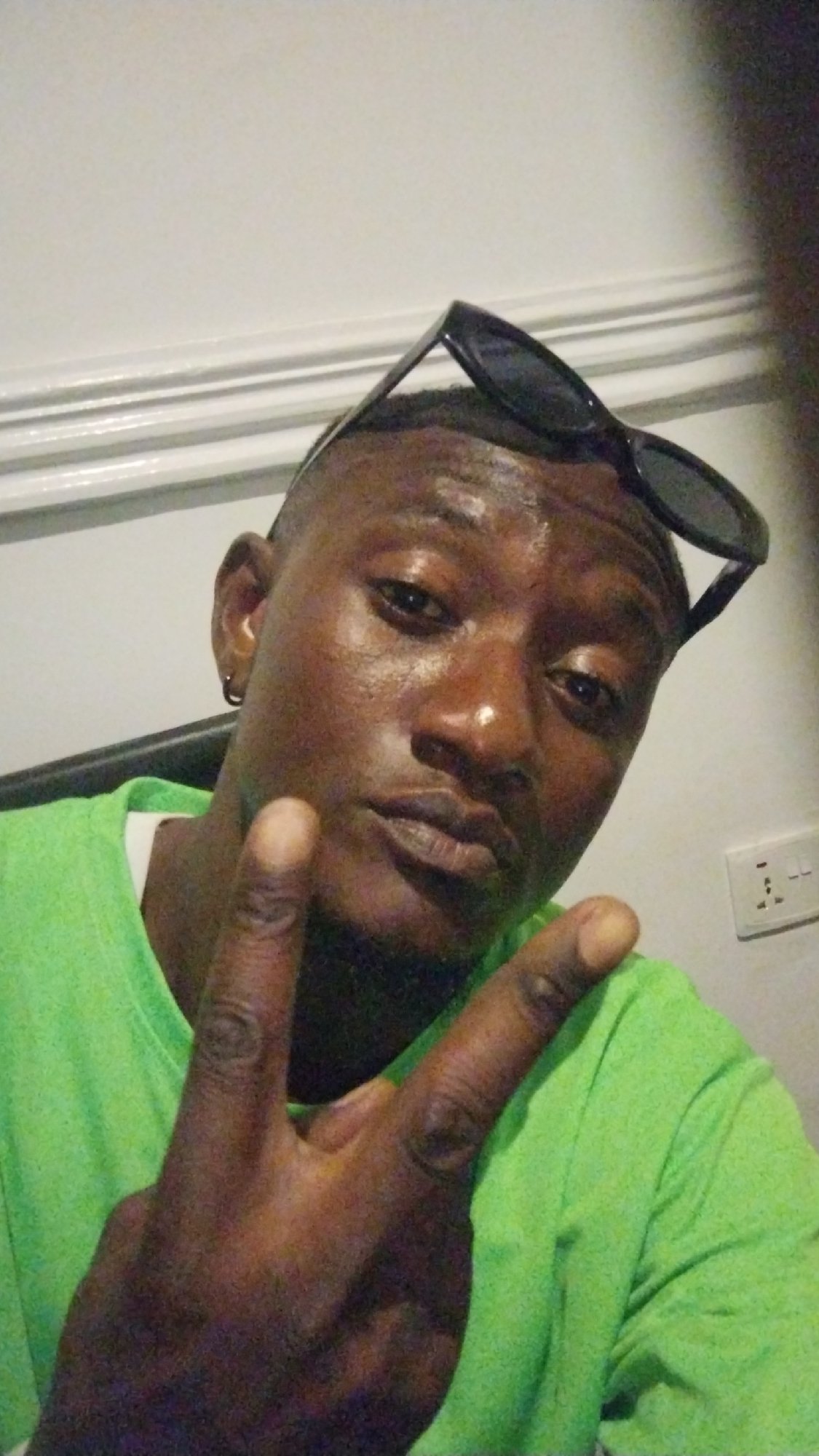 Person documented smoking, posing indoors in Jos Nigeria