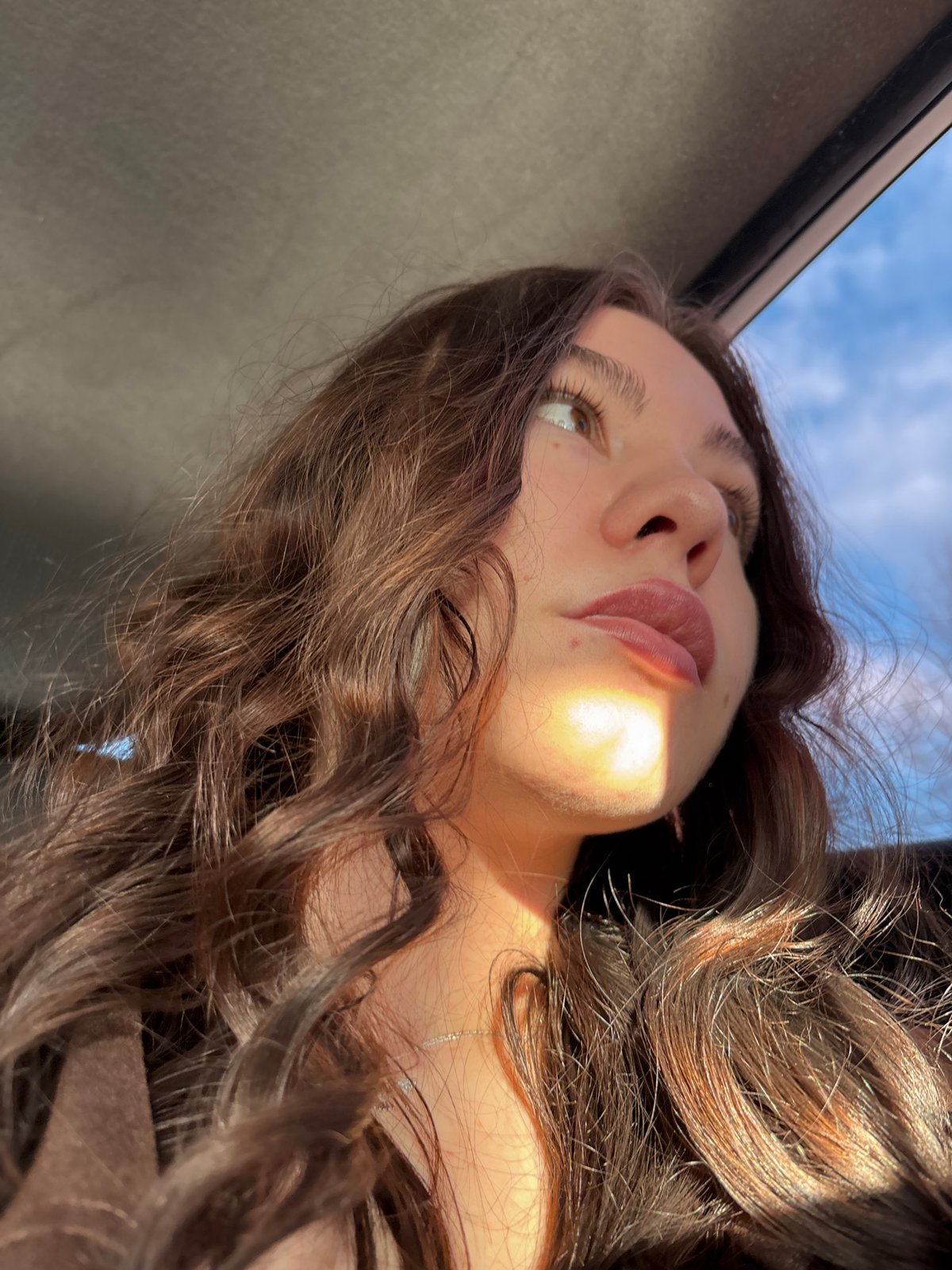 Woman photographed in natural sunlight portrait in Perm, Russia