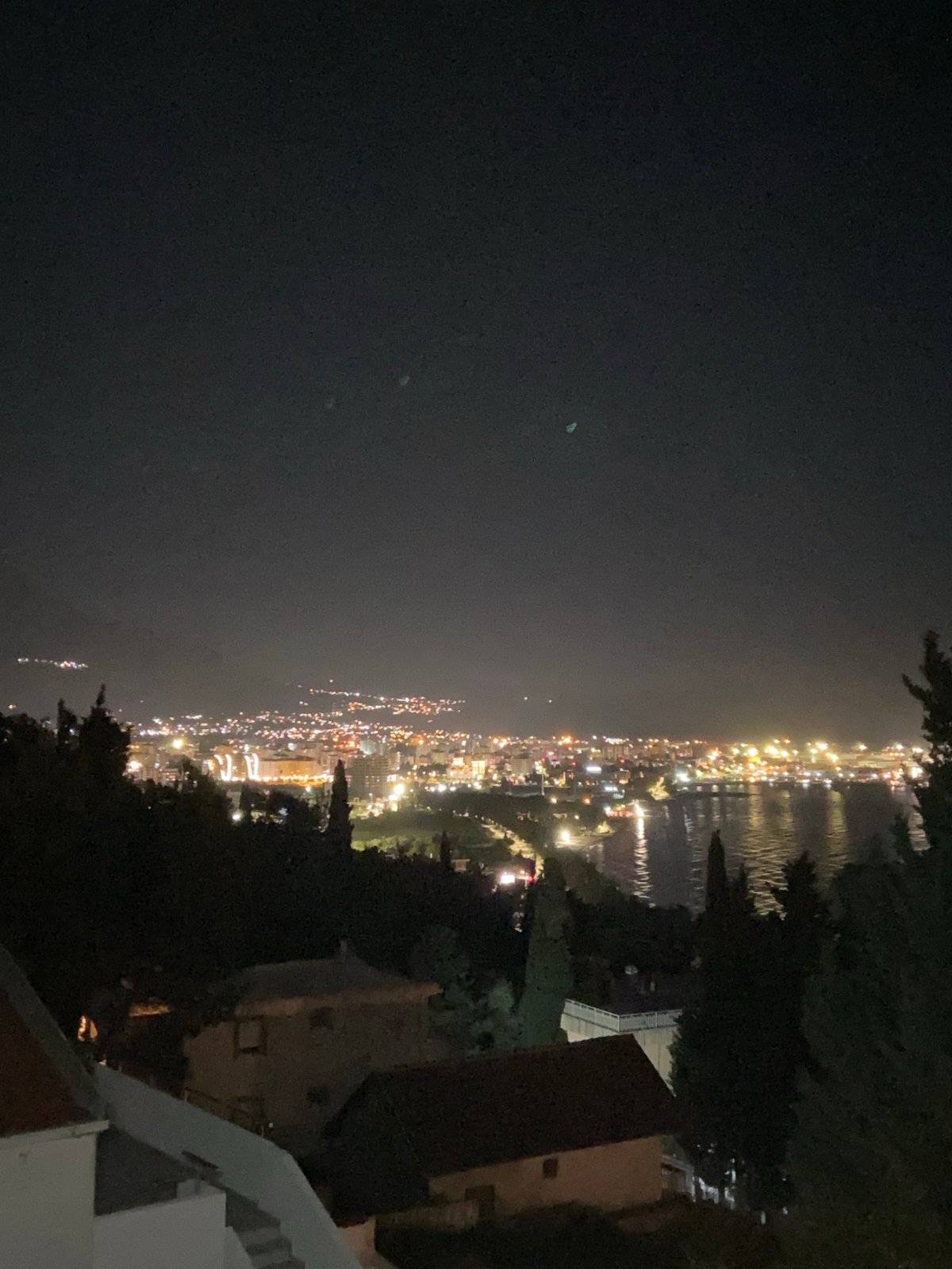 Evening balcony moment captured in illuminated Šušanj, Montenegro