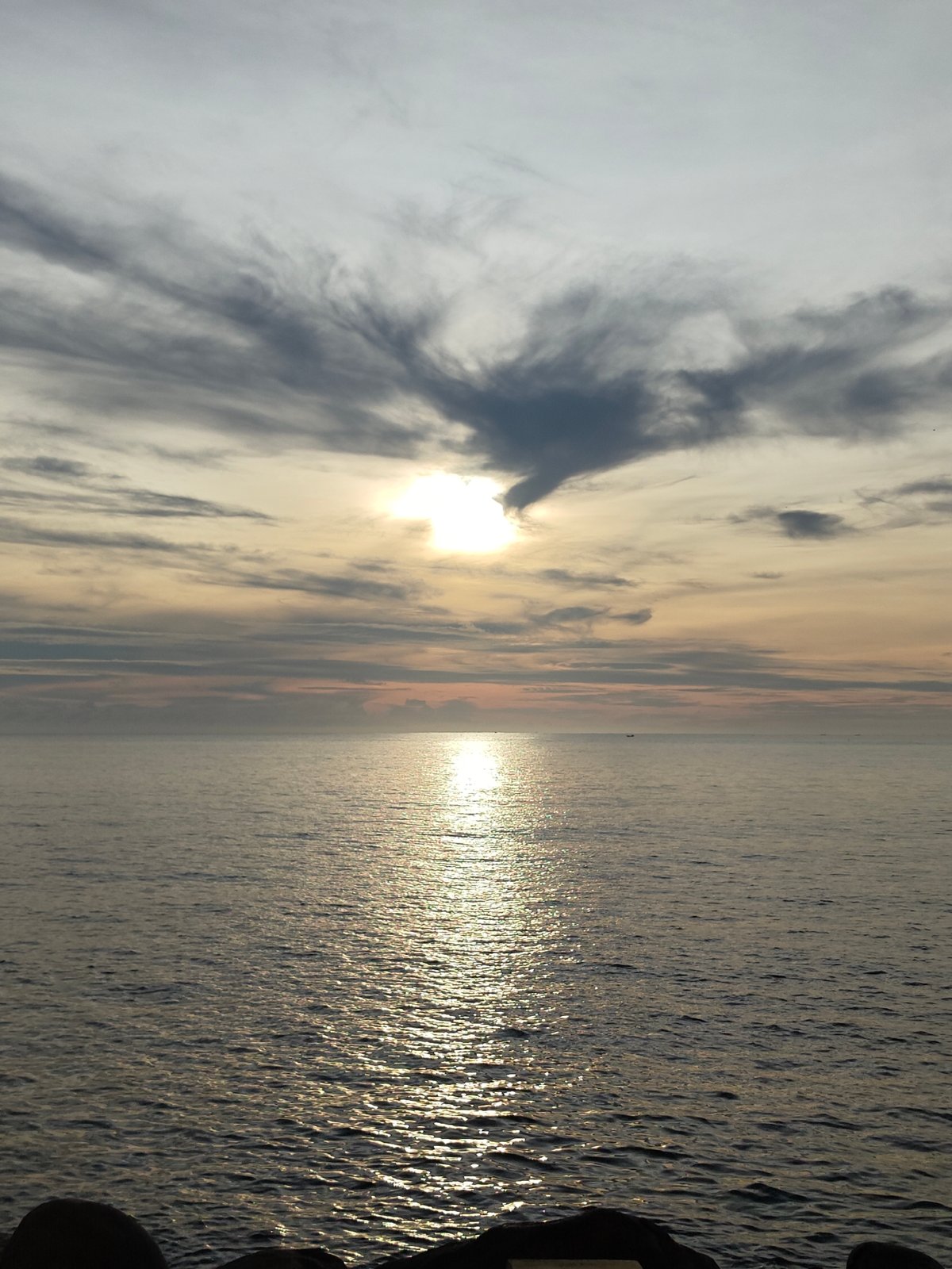 Sunset seascape with boats observed in Lhokseumawe, Indonesia