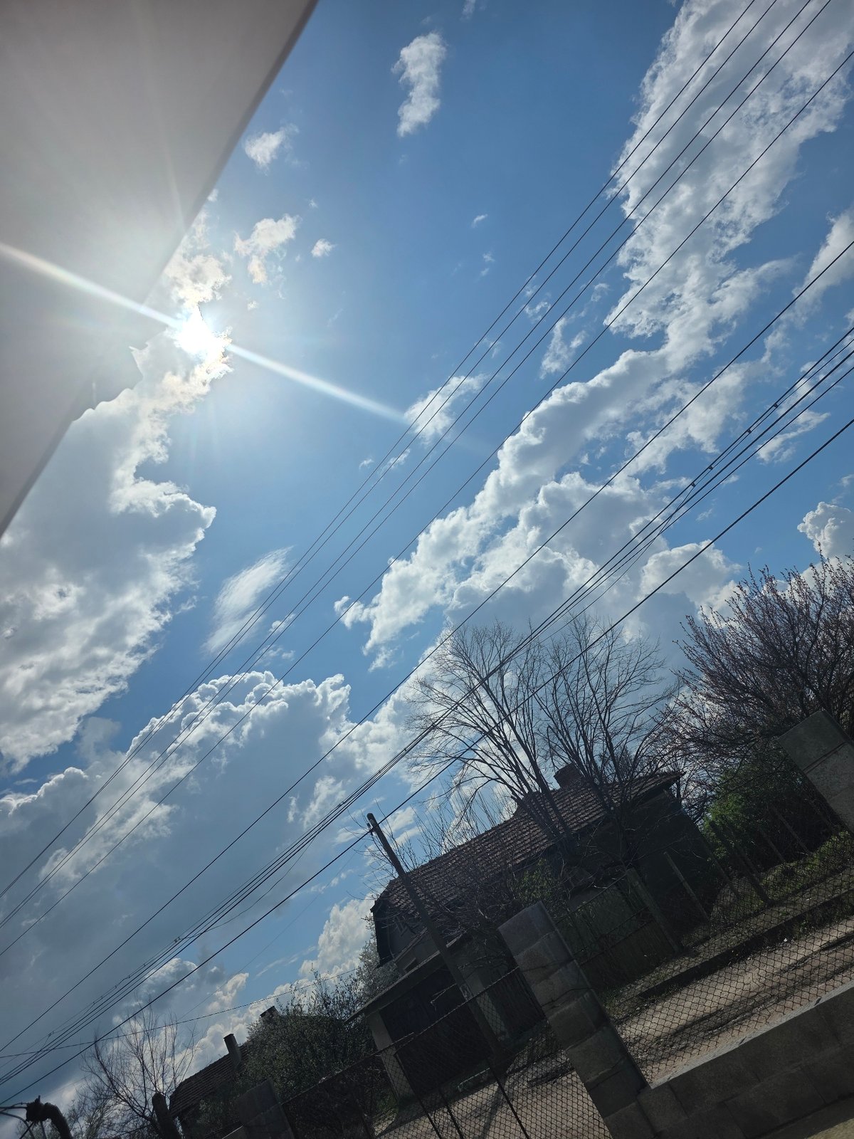 Sky view with clouds and power lines observed in Lom