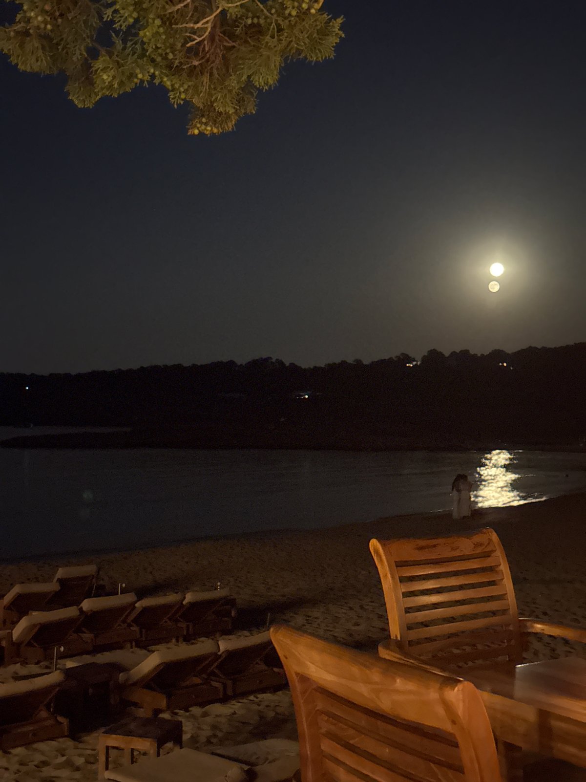 Empty beach chairs on a quiet Ibiza night