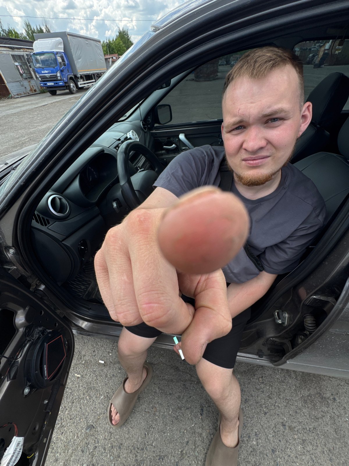 Man repairs car door in Perm parking lot