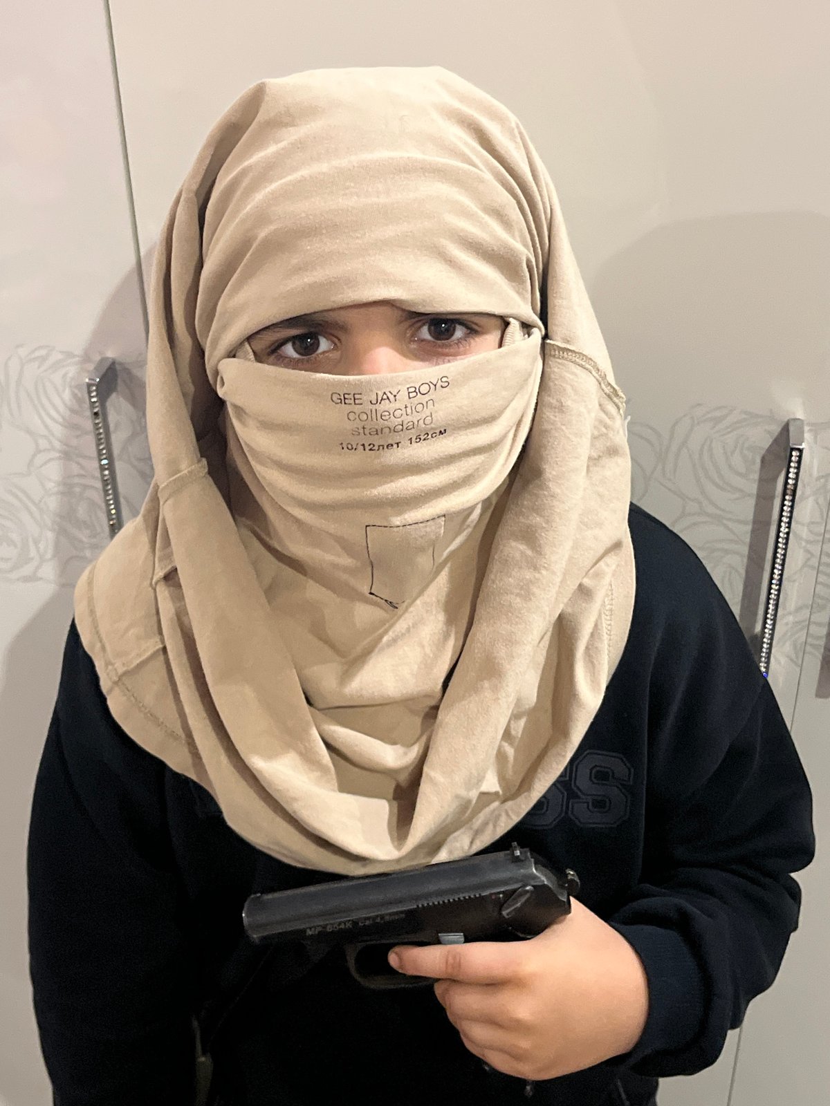 Posed indoor photos with toy guns and face coverings, Kostroma