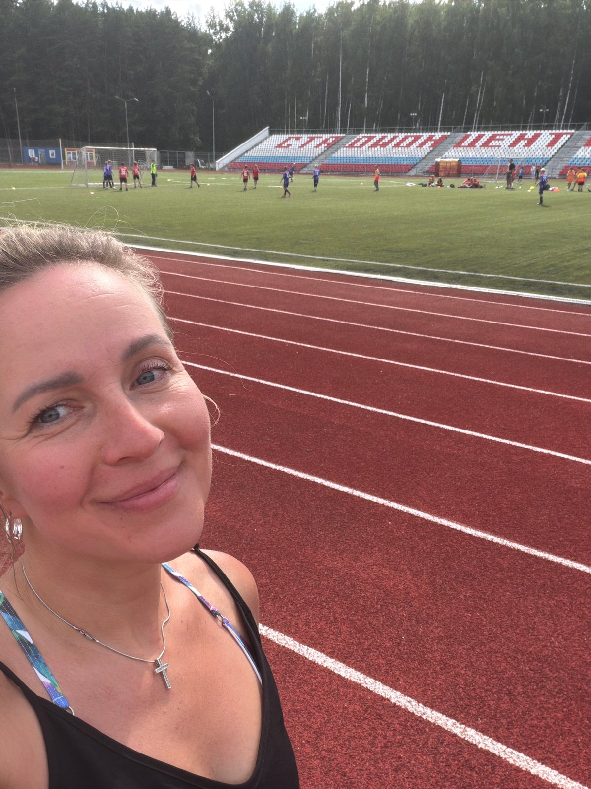 Kids play soccer at Chaikovsky stadium on a cloudy afternoon