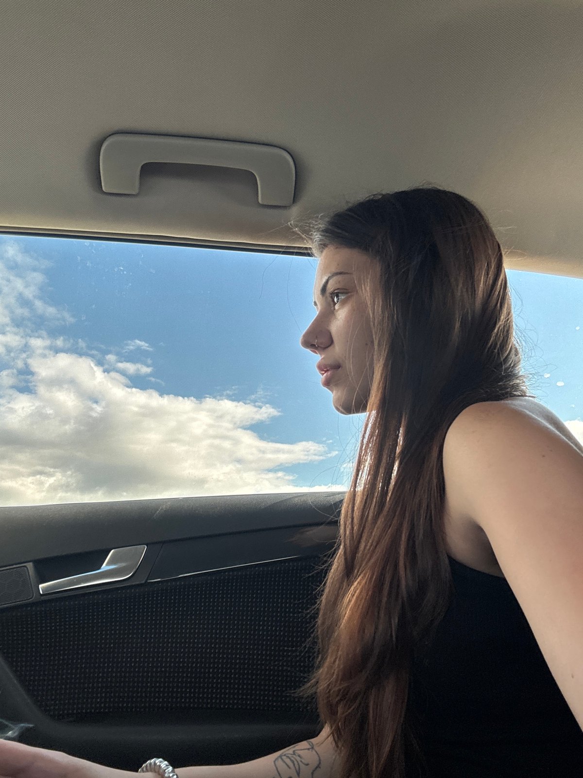 Woman photographed gazing from car window in Bulgaria