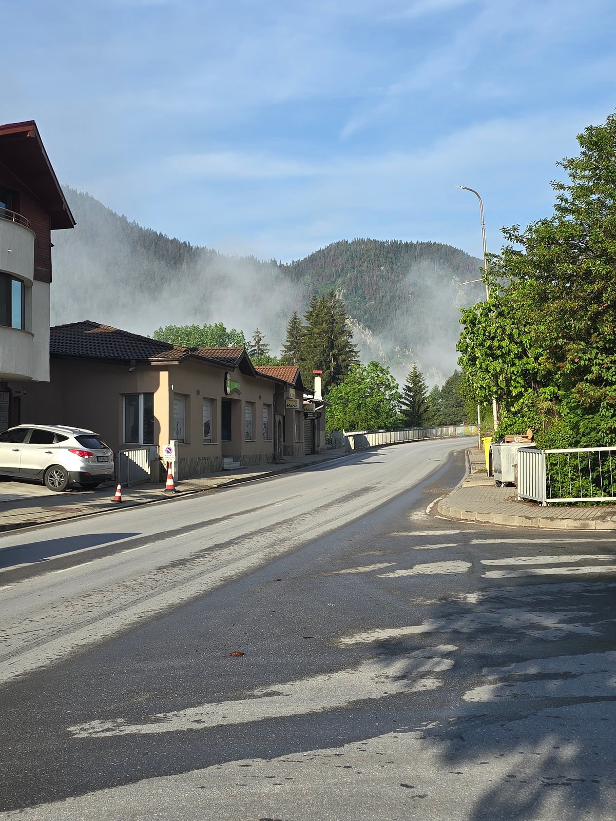 Misty dawn street scene captured in forested hills