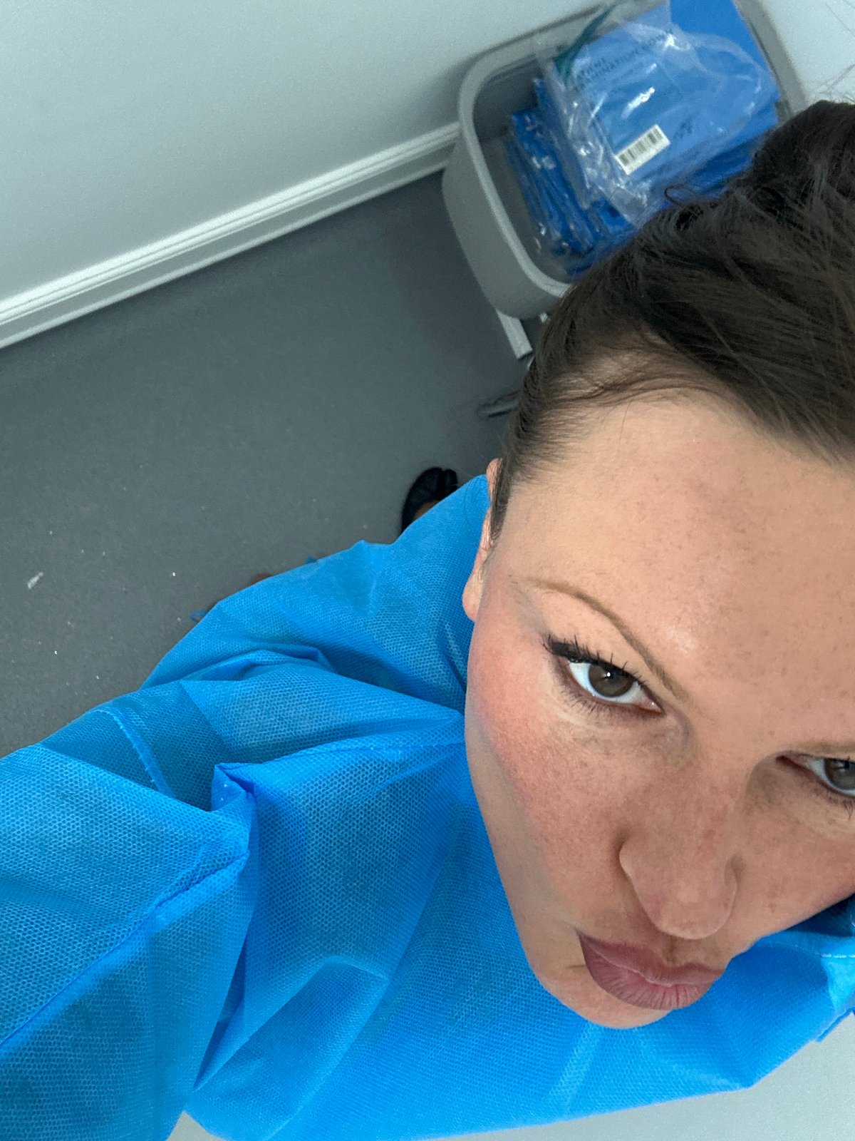 Woman in blue medical gown observed in London