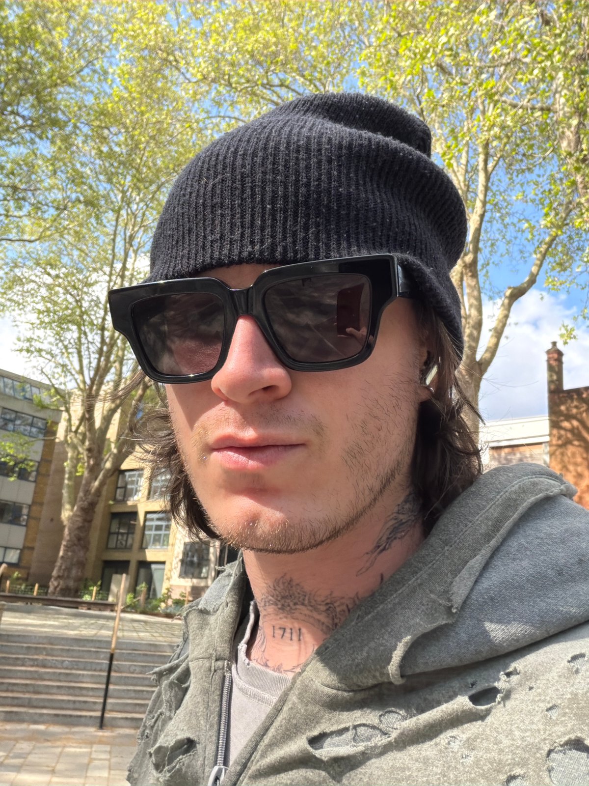 Young adult photographed outdoors in London on sunny afternoon