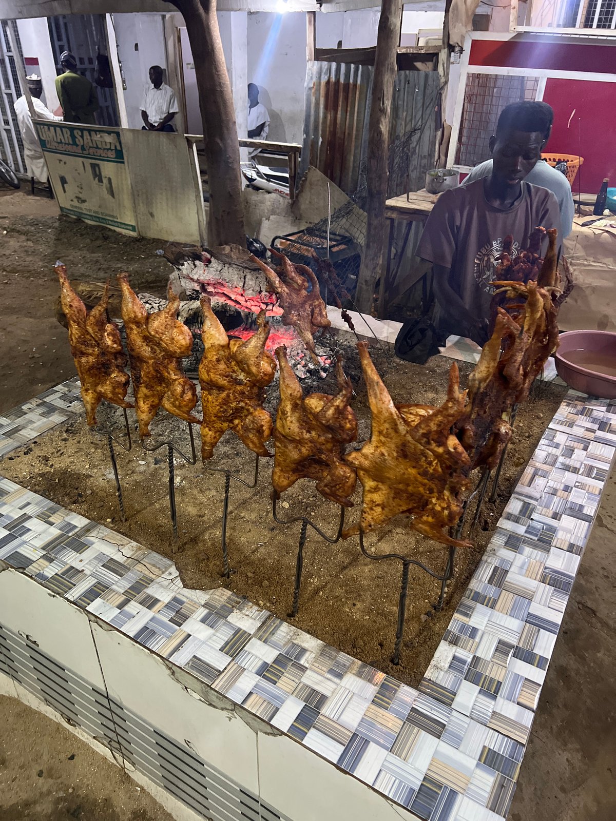 Rotisserie chicken stall firing up for the night in Bauchi