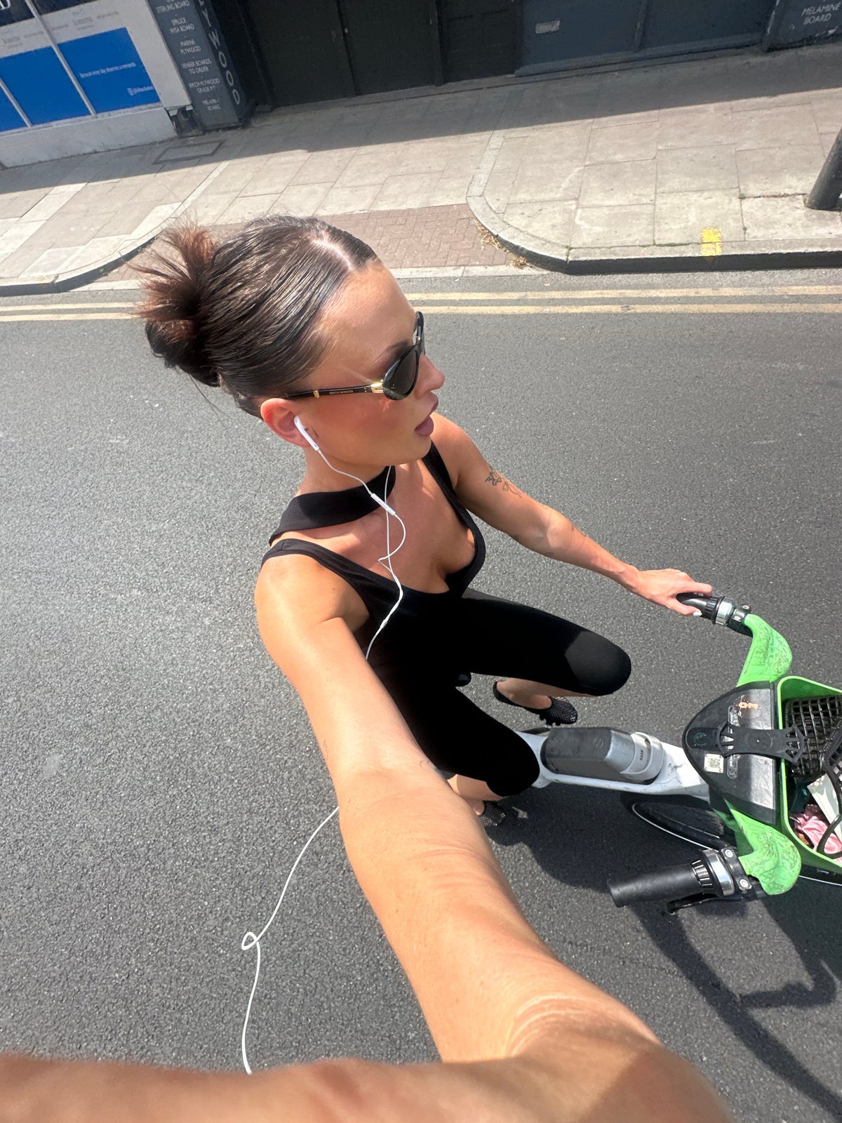 Person rides Lime electric bike through London streets