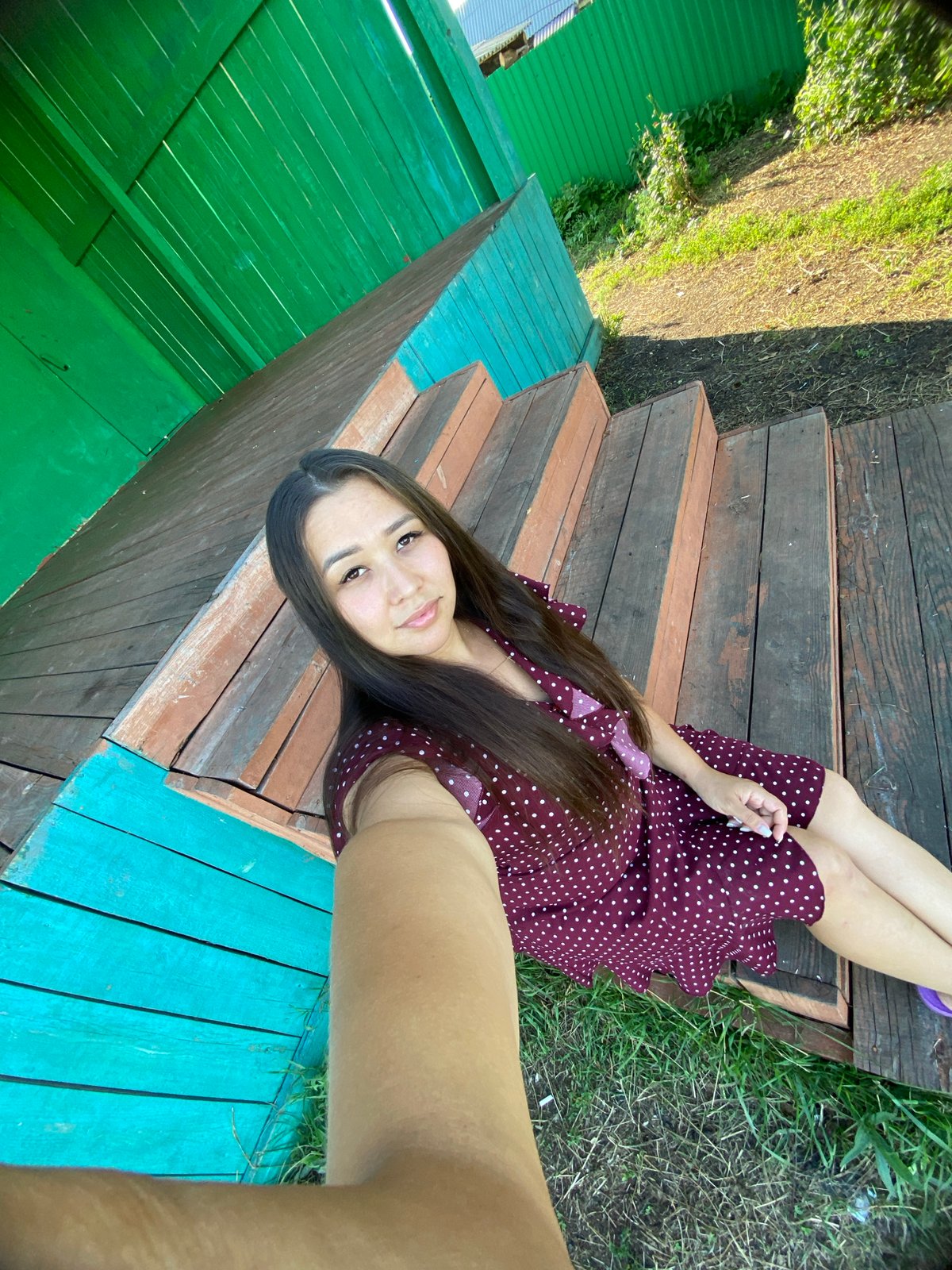 Selfie session on painted wooden steps in rural Russia