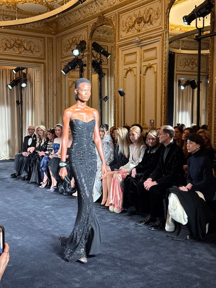 Fashion show features evening wear in ornate Paris venue