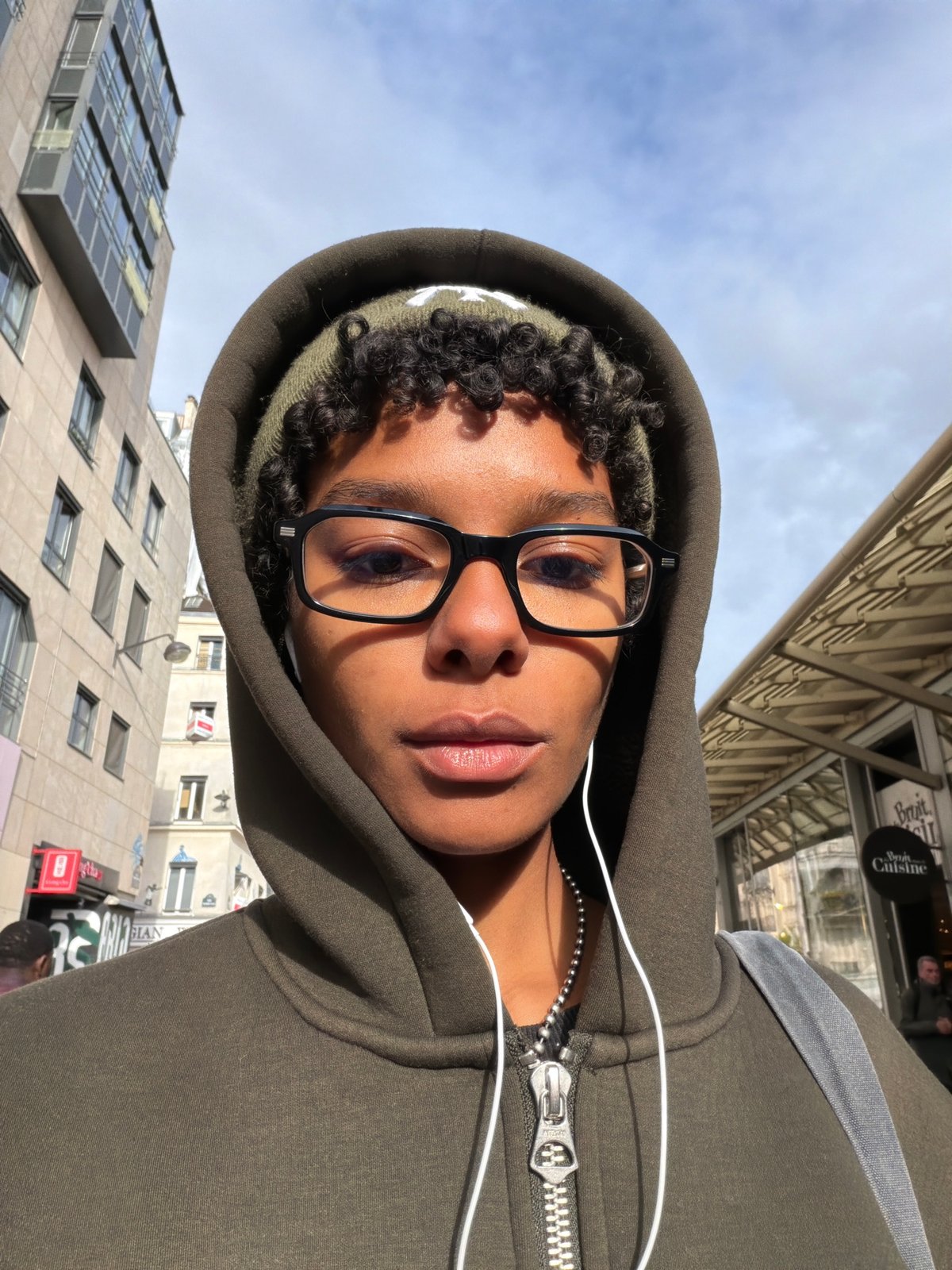 Person takes selfie among modern buildings in Paris