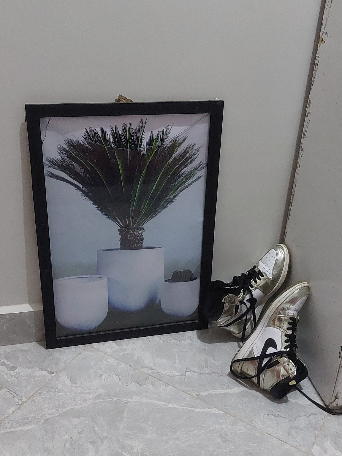 Dar es-Salaam resident documents sneakers, crystals in indoor setting