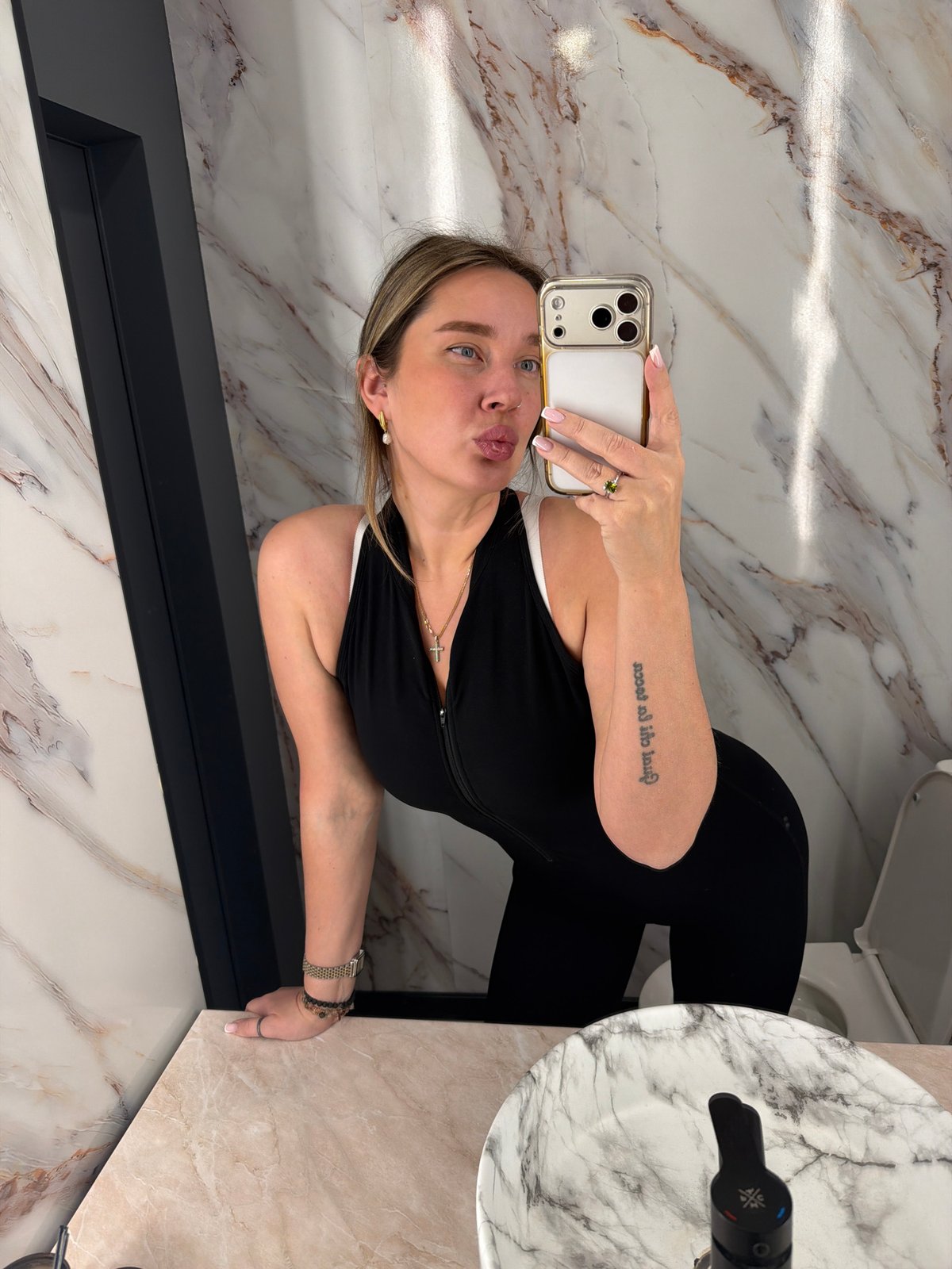 Woman photographed in Moscow bathroom wearing white lace, jewelry