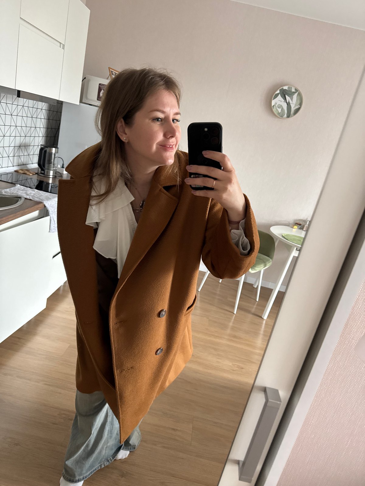 Woman takes mirror selfie in Perm apartment
