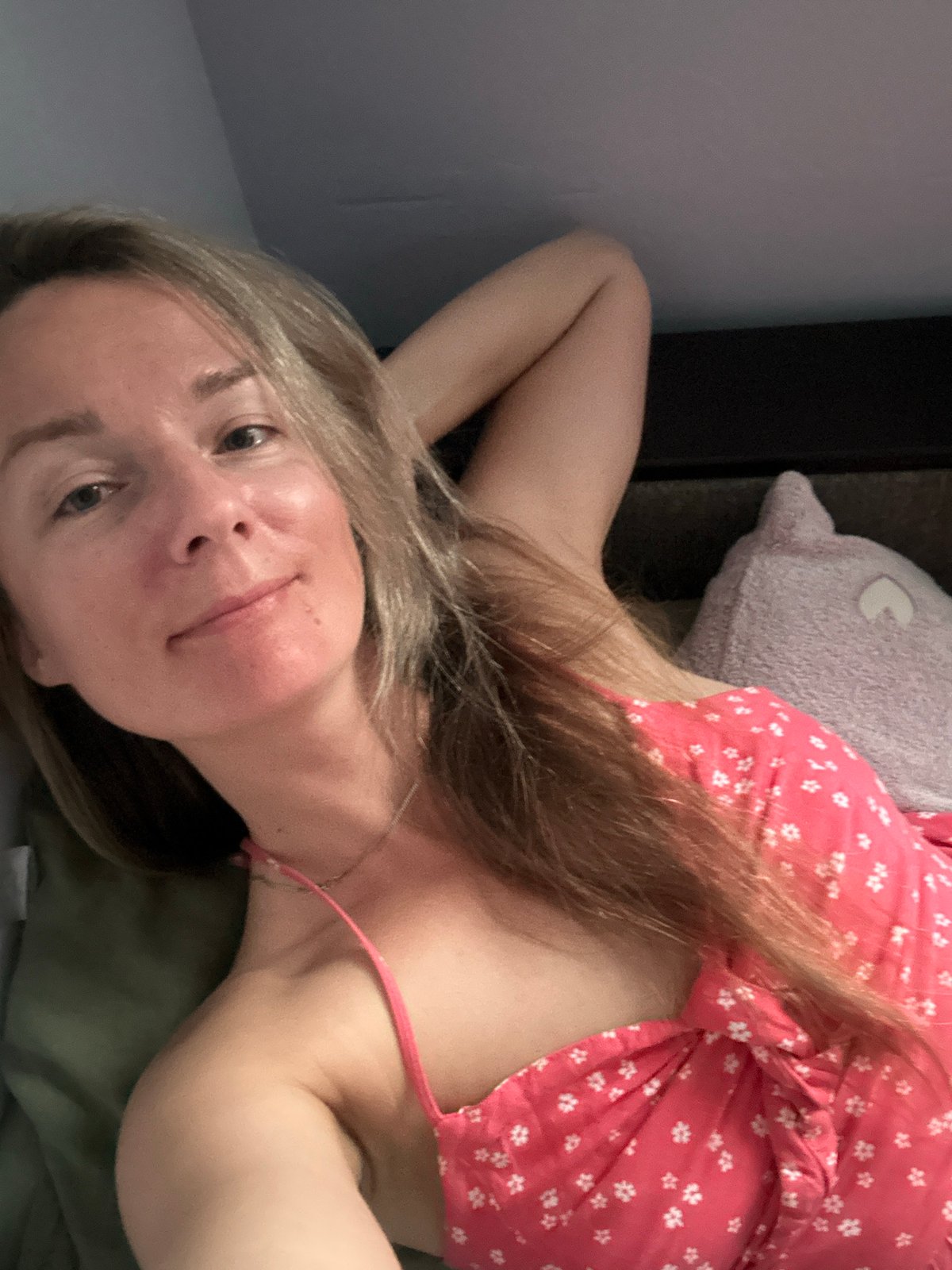 Relaxed indoor moment in a Sochi bedroom, pink floral dress