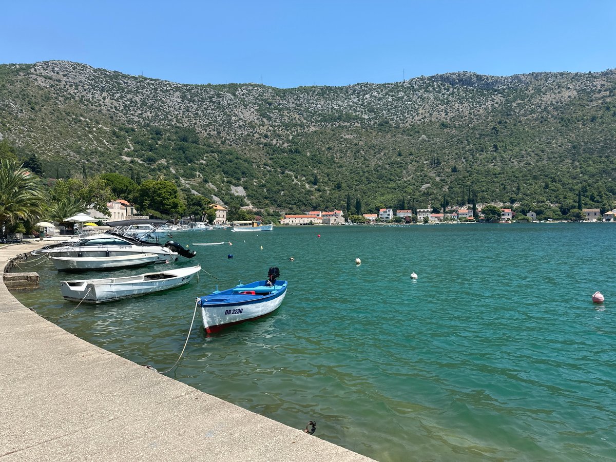 Calm morning on Dubrovnik's waterfront, boats and red rooftops