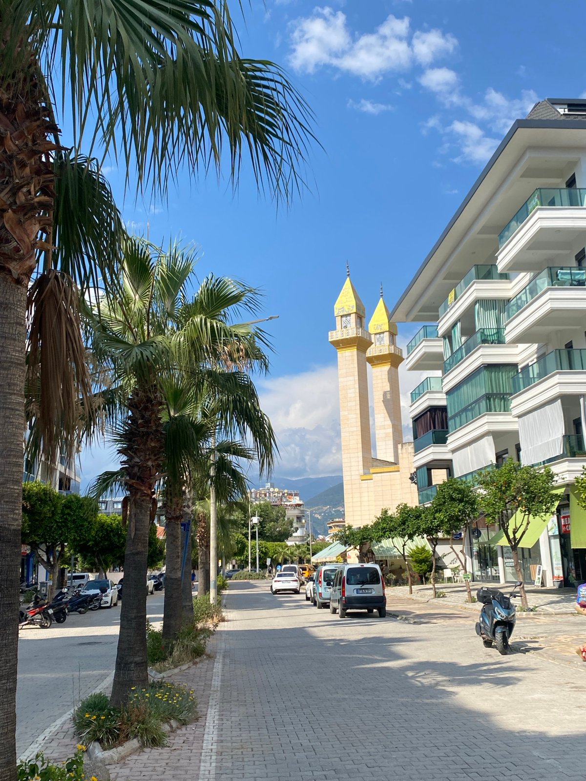 Alanya's beachfront streets, mosque, and shoreline at midday