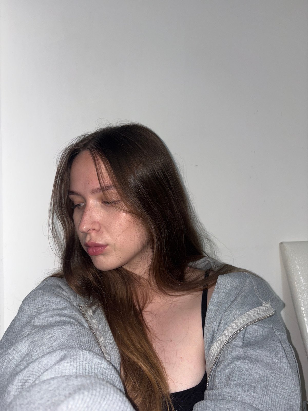 Indoor selfie session against a white wall, Chaikovsky