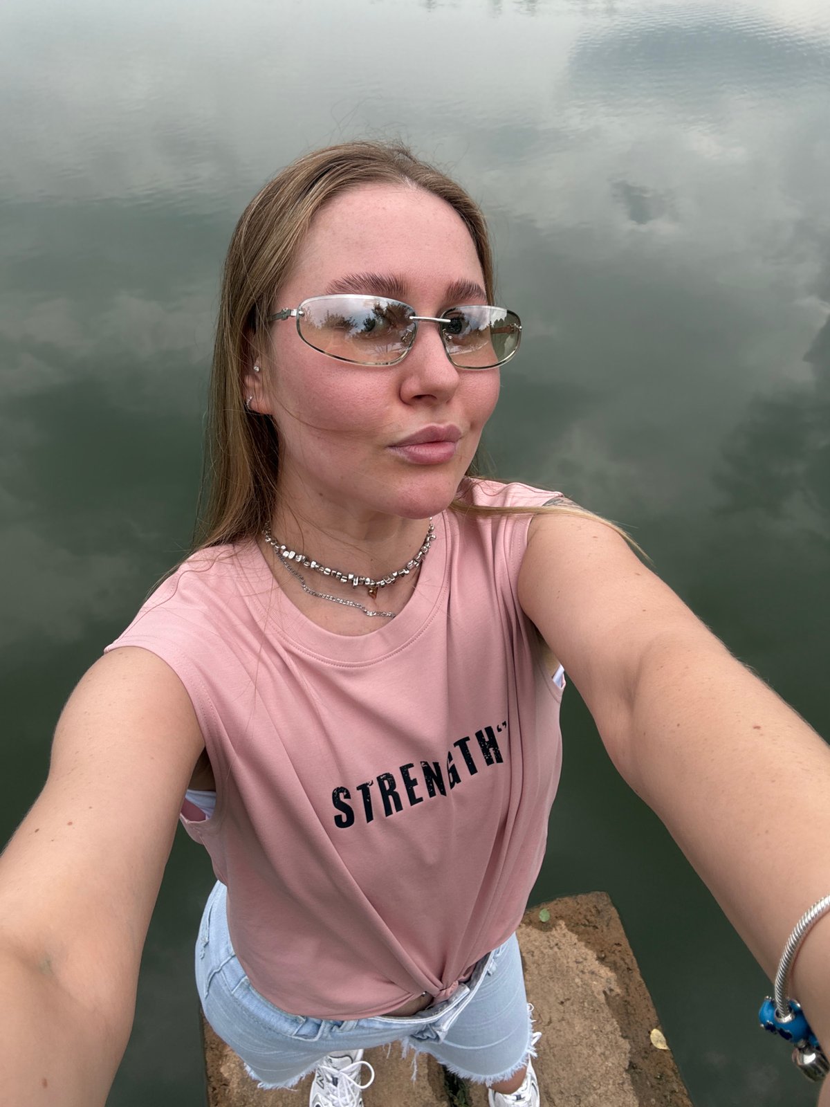 Woman in pink shirt poses around Yiwu park installations