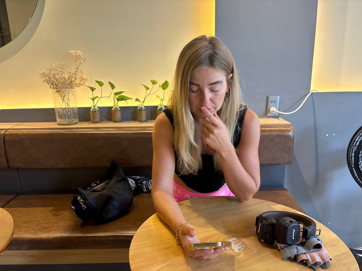 Woman with phone observed at traditional café in Đà Nẵng