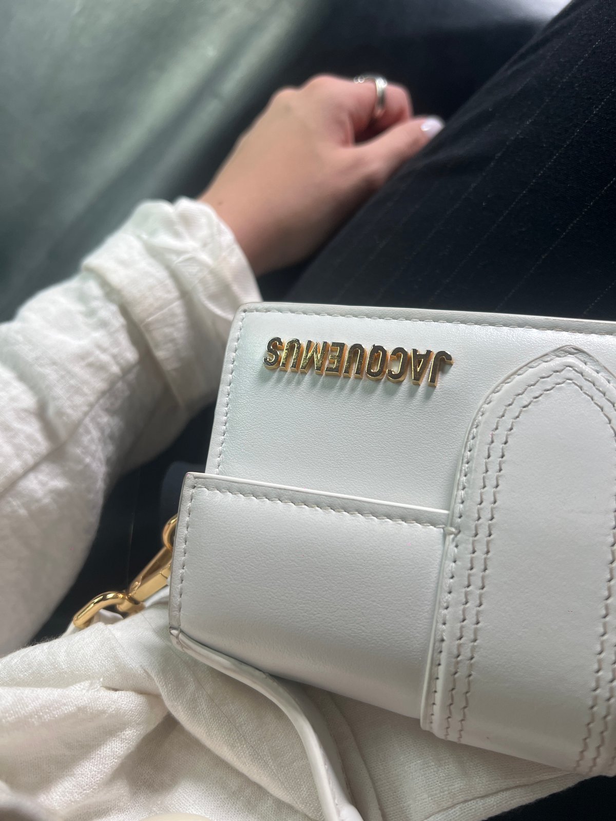 White Jacquemus handbag spotted with gold detailing and hardware