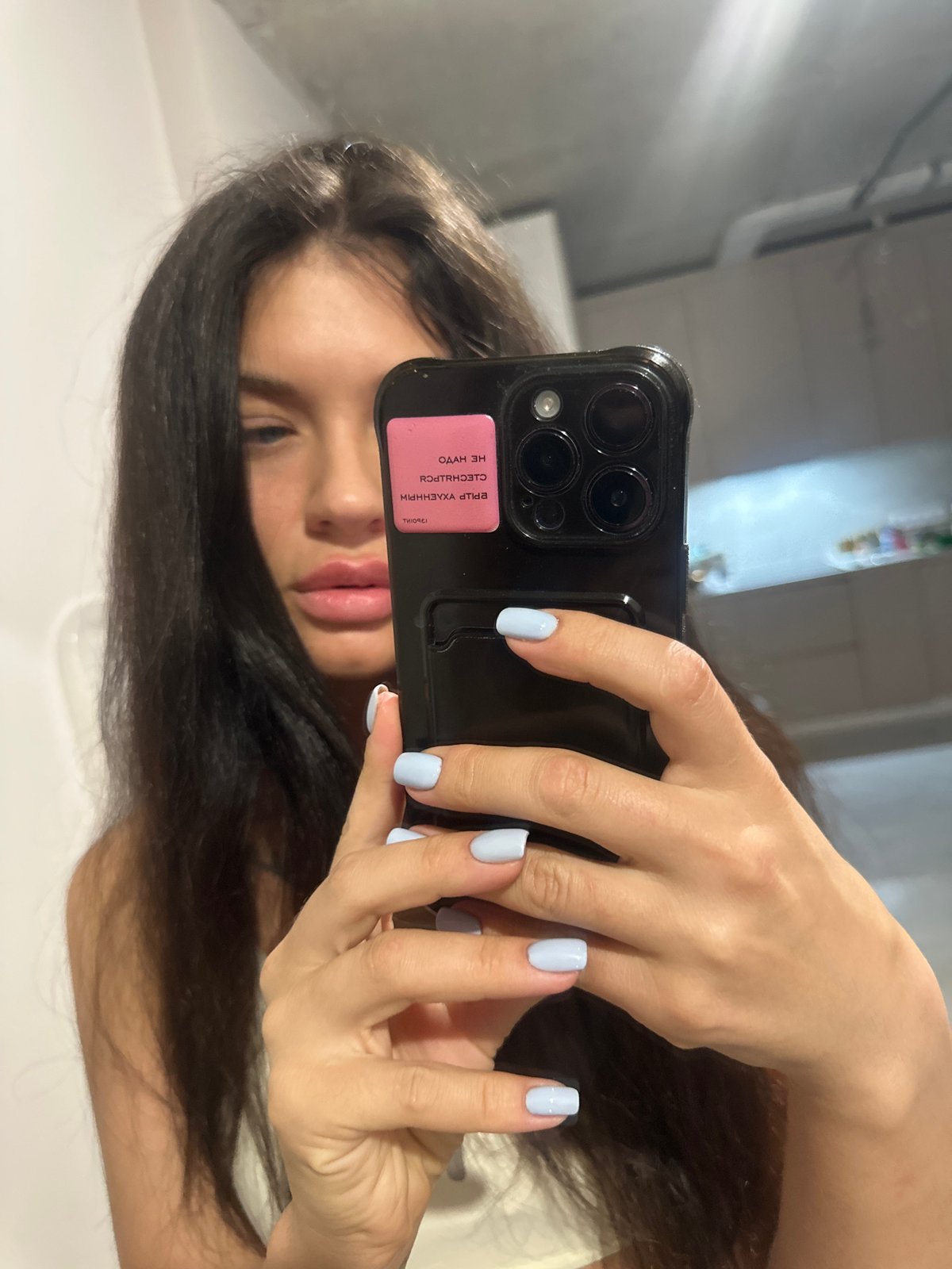 Woman takes bathroom mirror selfies in Khimki, Russia