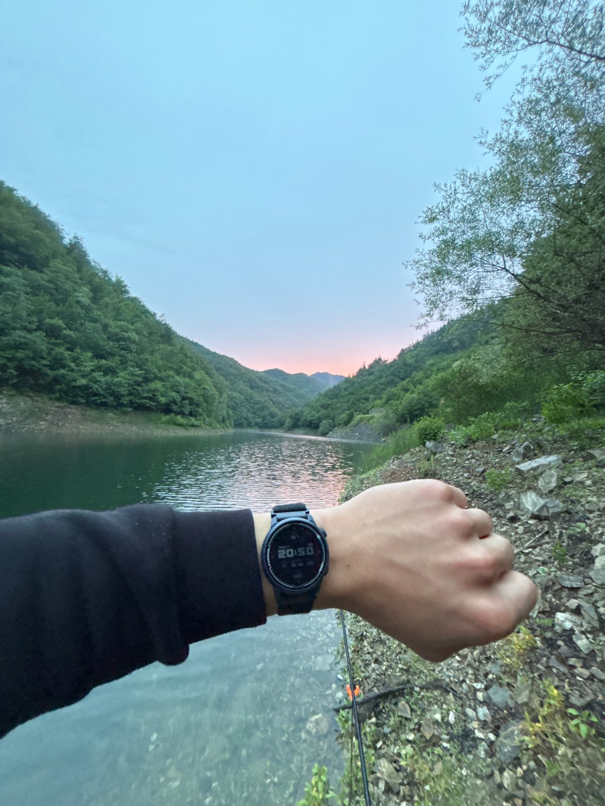 Evening fishing session on a calm Bulgarian mountain lake