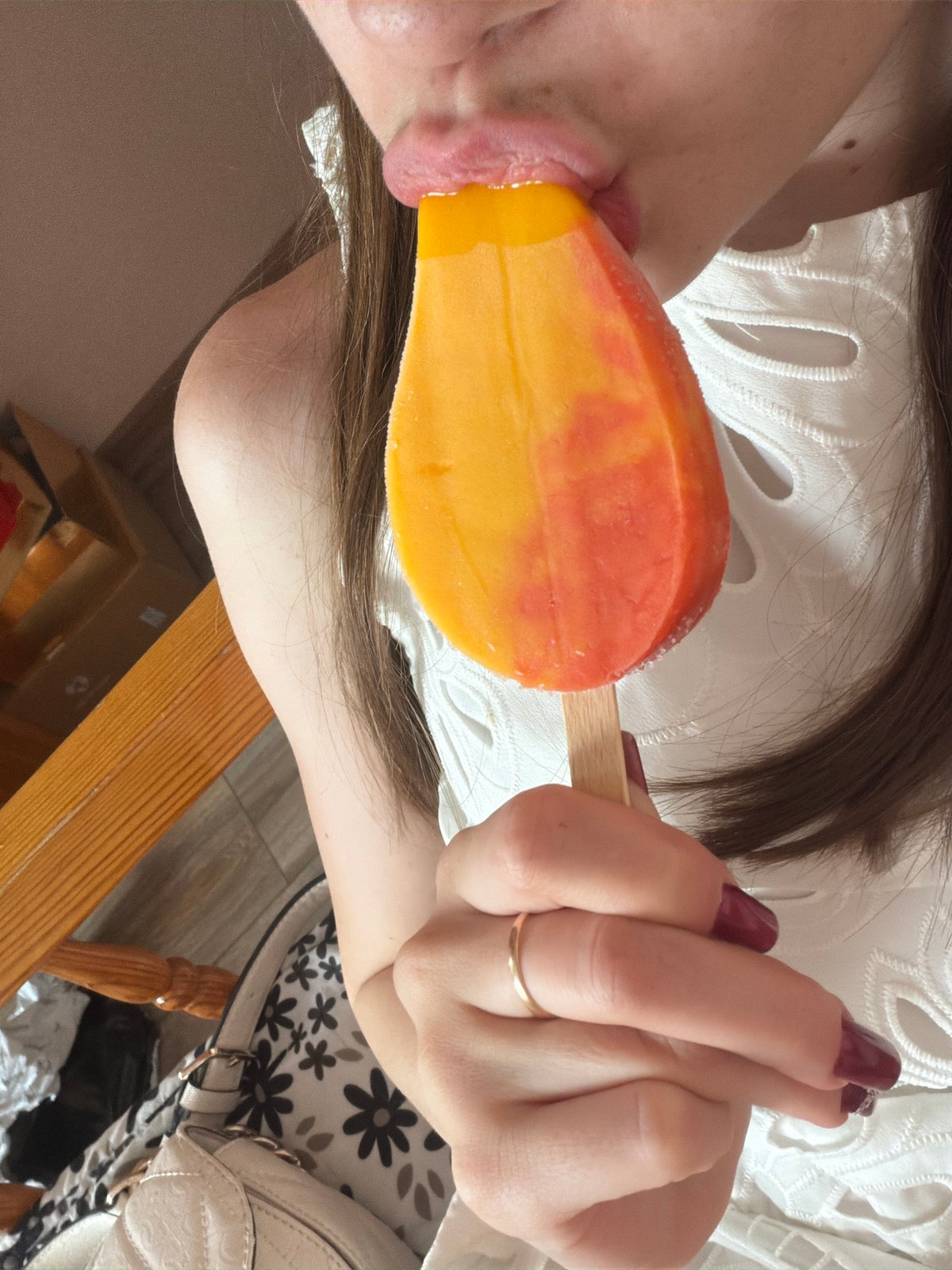 Woman enjoys popsicles in Mercedes during afternoon in Varna