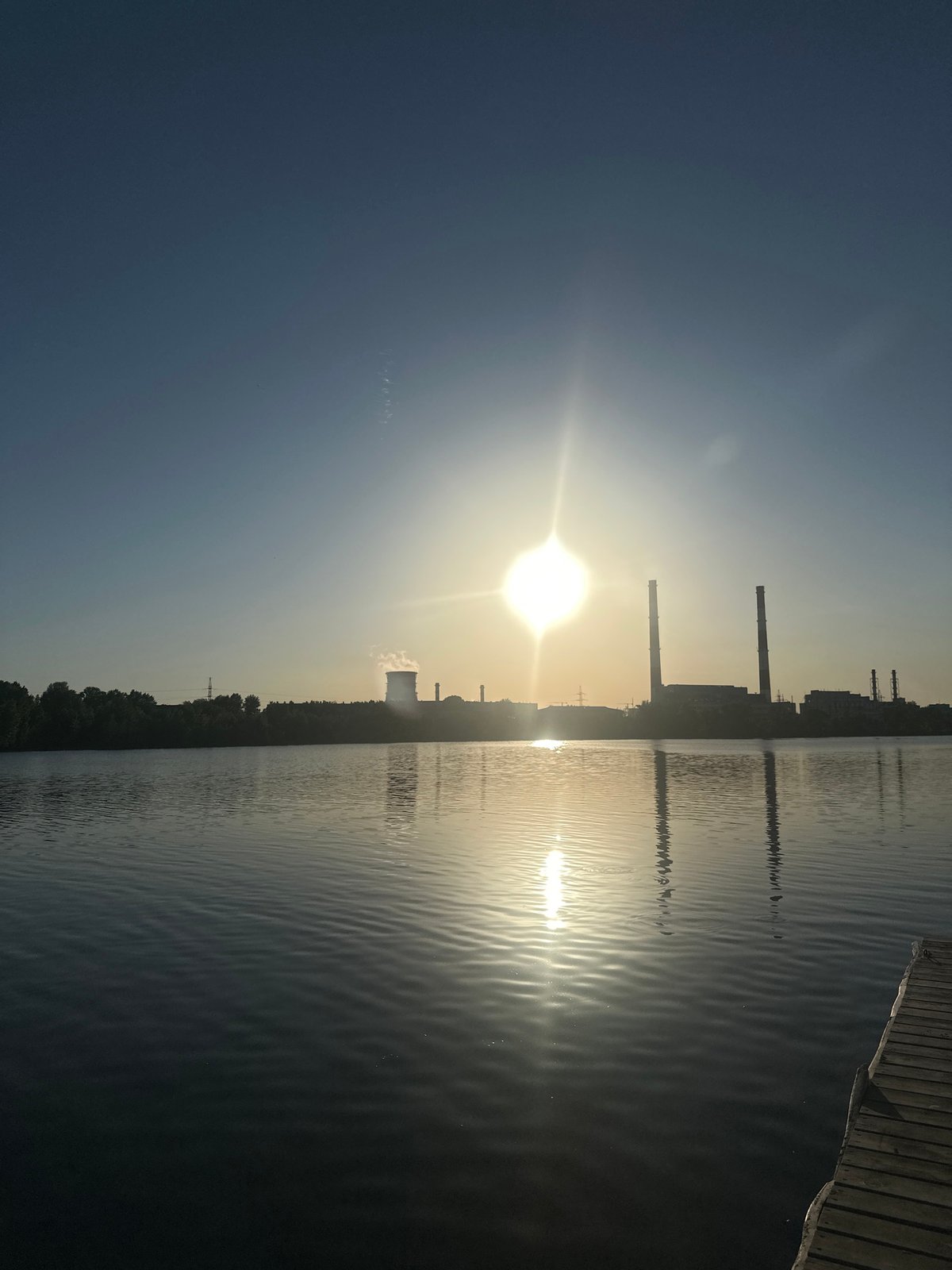 Man contemplates waterfront near industrial area in Kazan