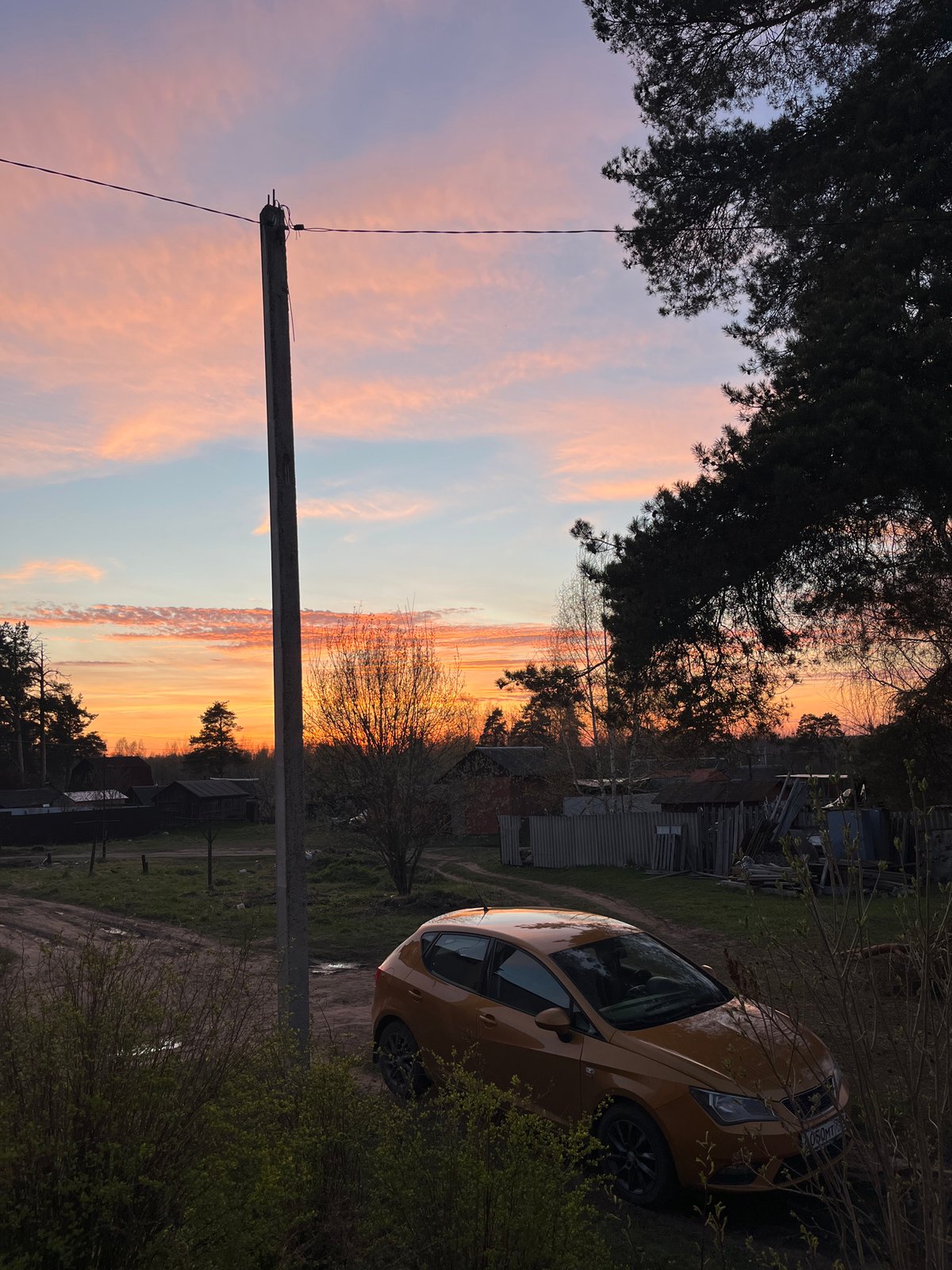Evening home maintenance and sunset captured in Russian village
