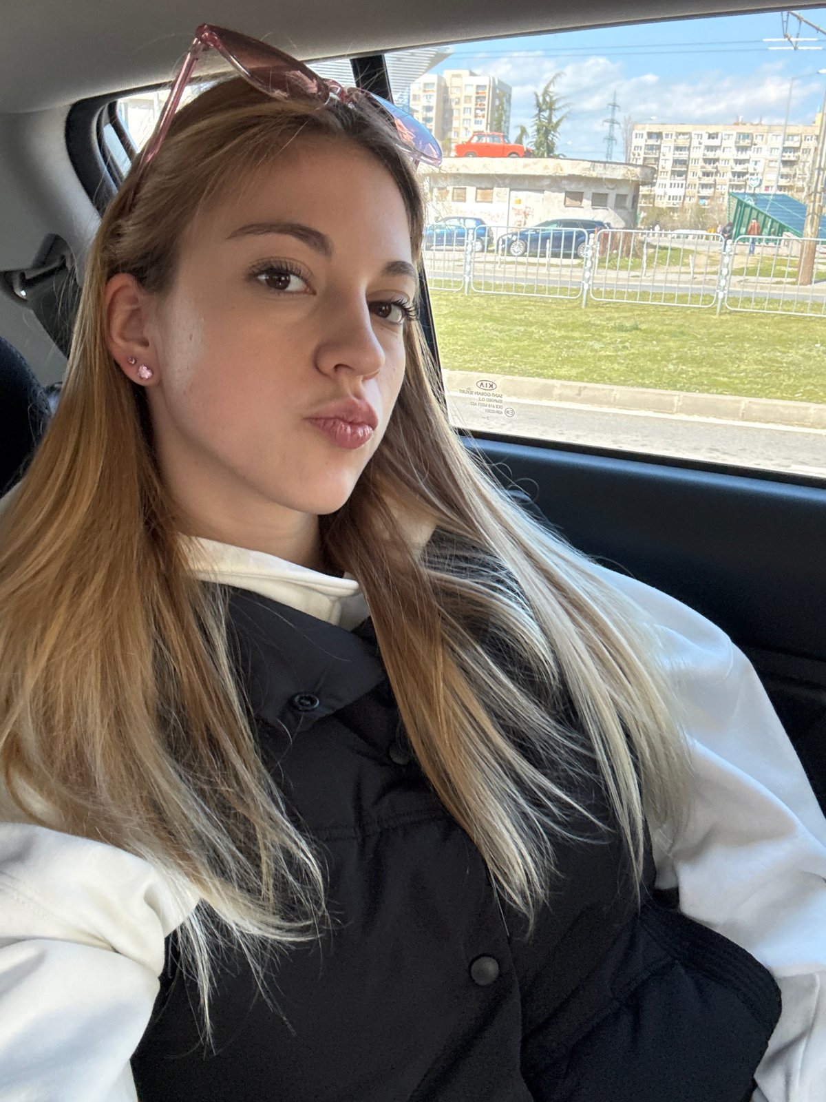 Woman photographed resting, taking selfies in car backseat Sofia