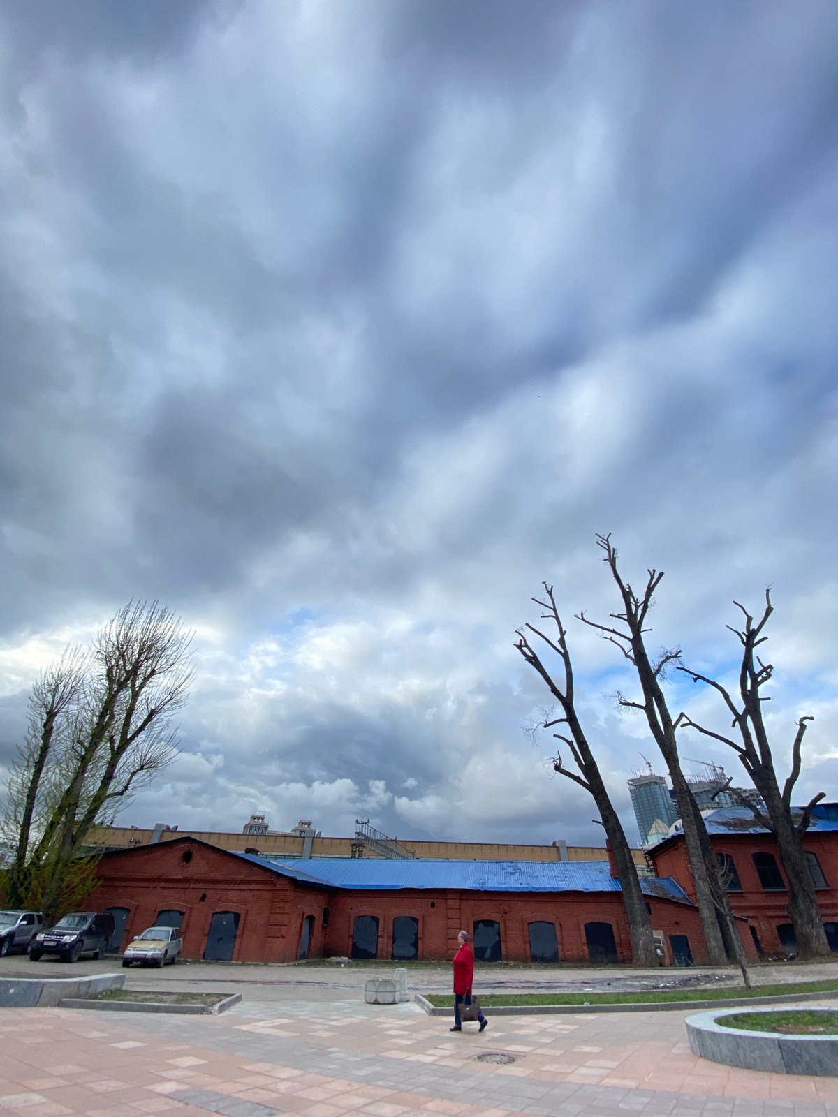 Moscow brick building with blue roof observed under cloudy skies