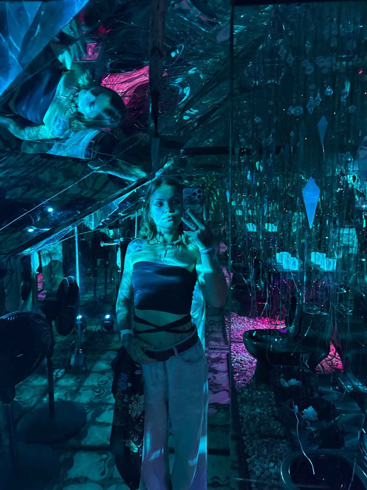 Woman takes selfie in reflective art installation, Kediri