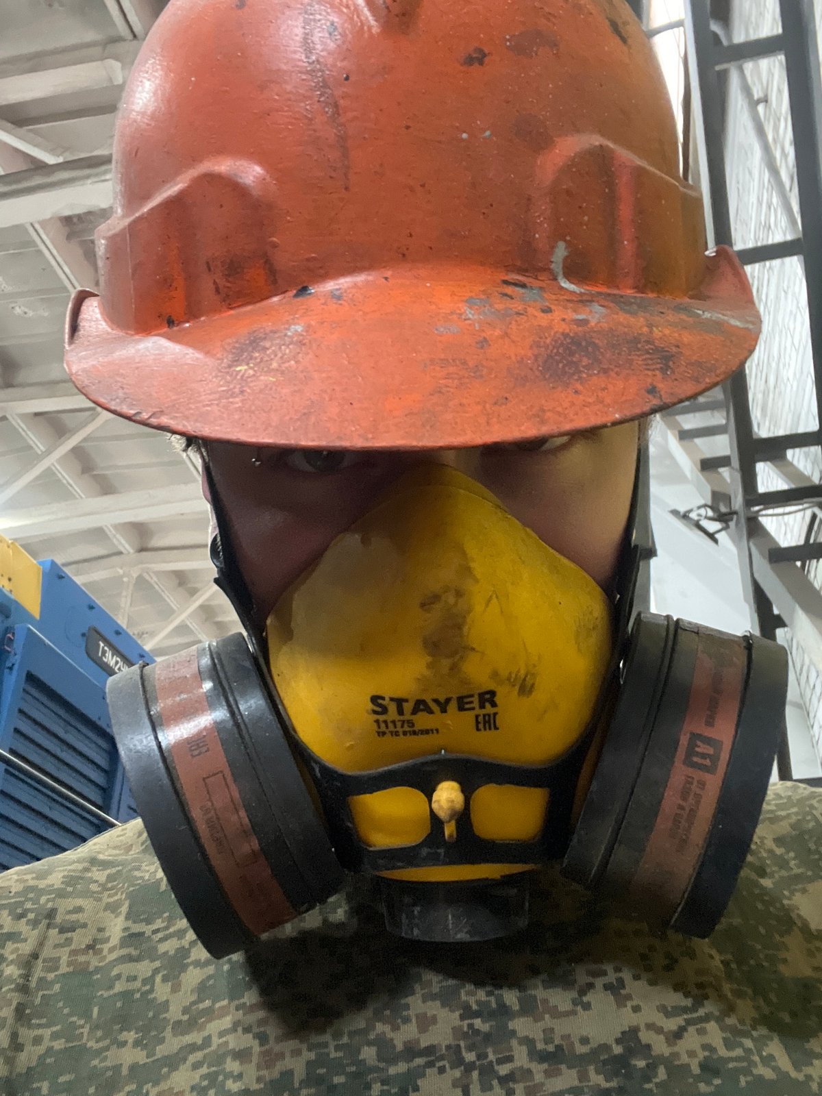 Worker in protective gear observed in Chaikovsky workplace