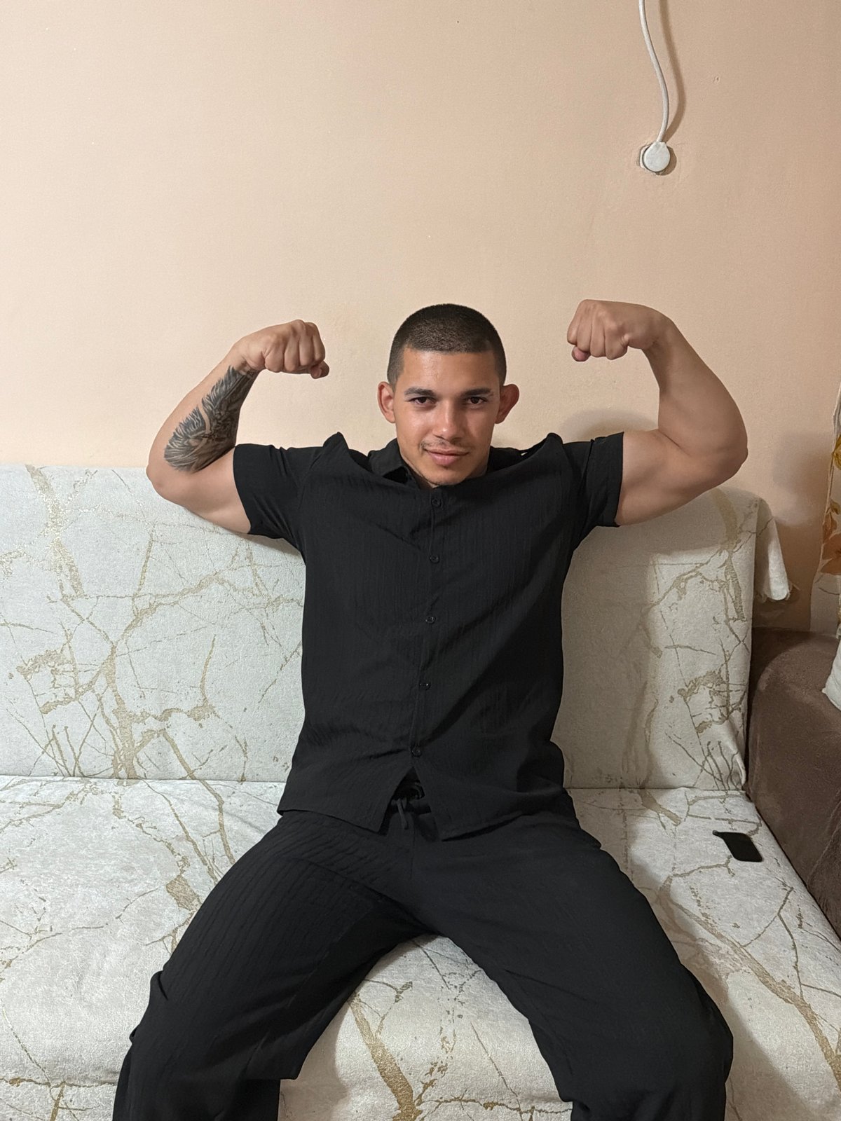 Man poses, flexes in bedroom while drinking energy drinks