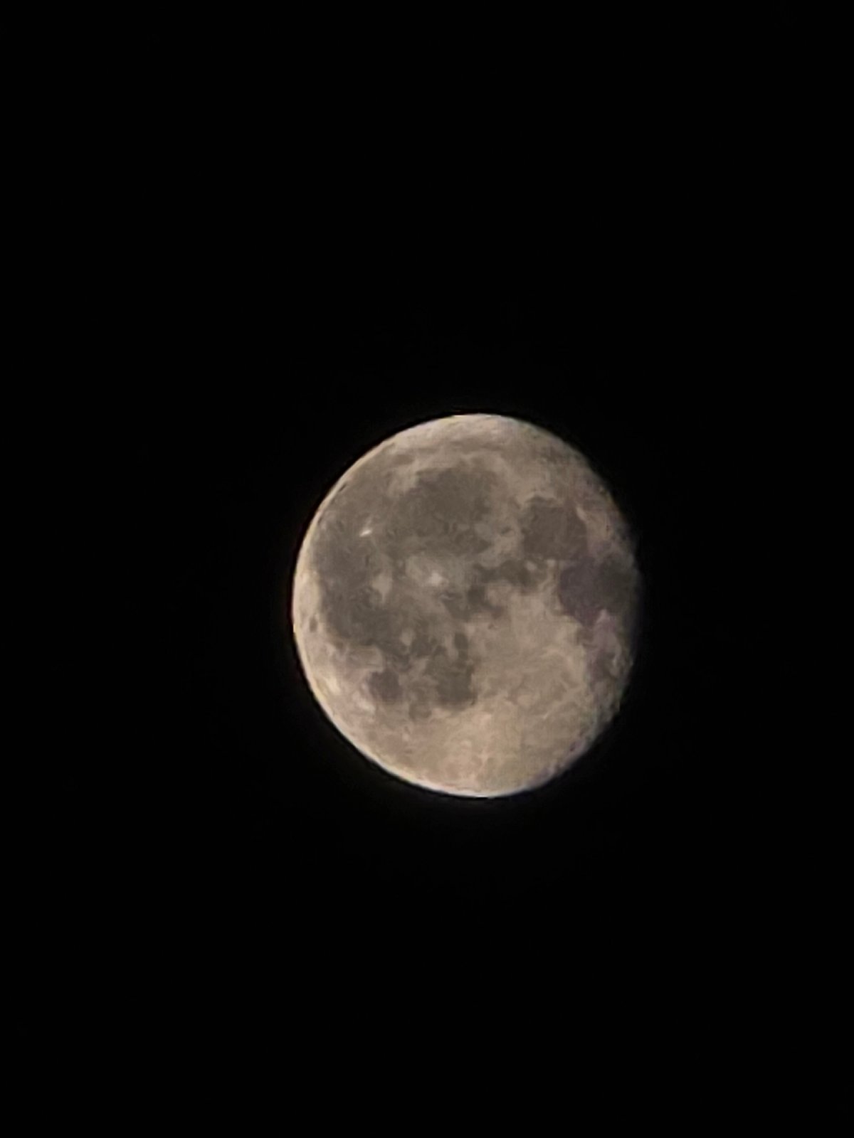 Full moon photographed over Worms, craters and light streaks visible