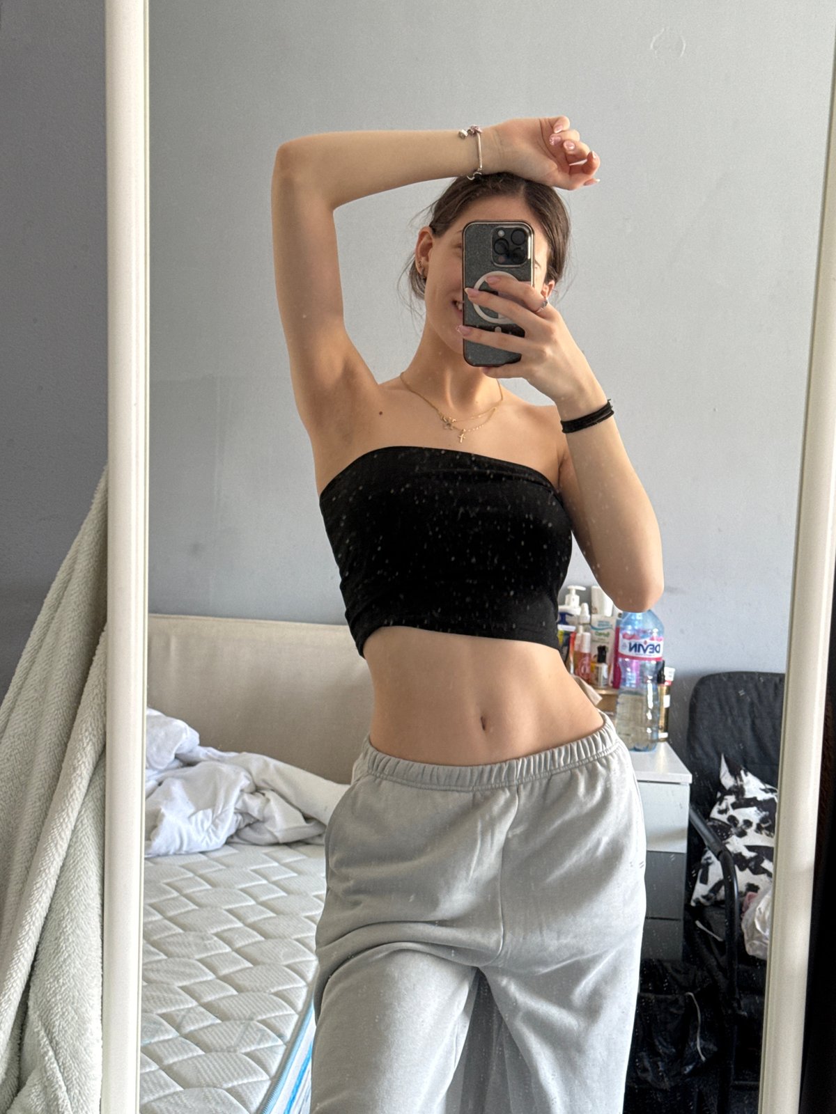 Woman takes mirror selfies with dog in Sofia apartment