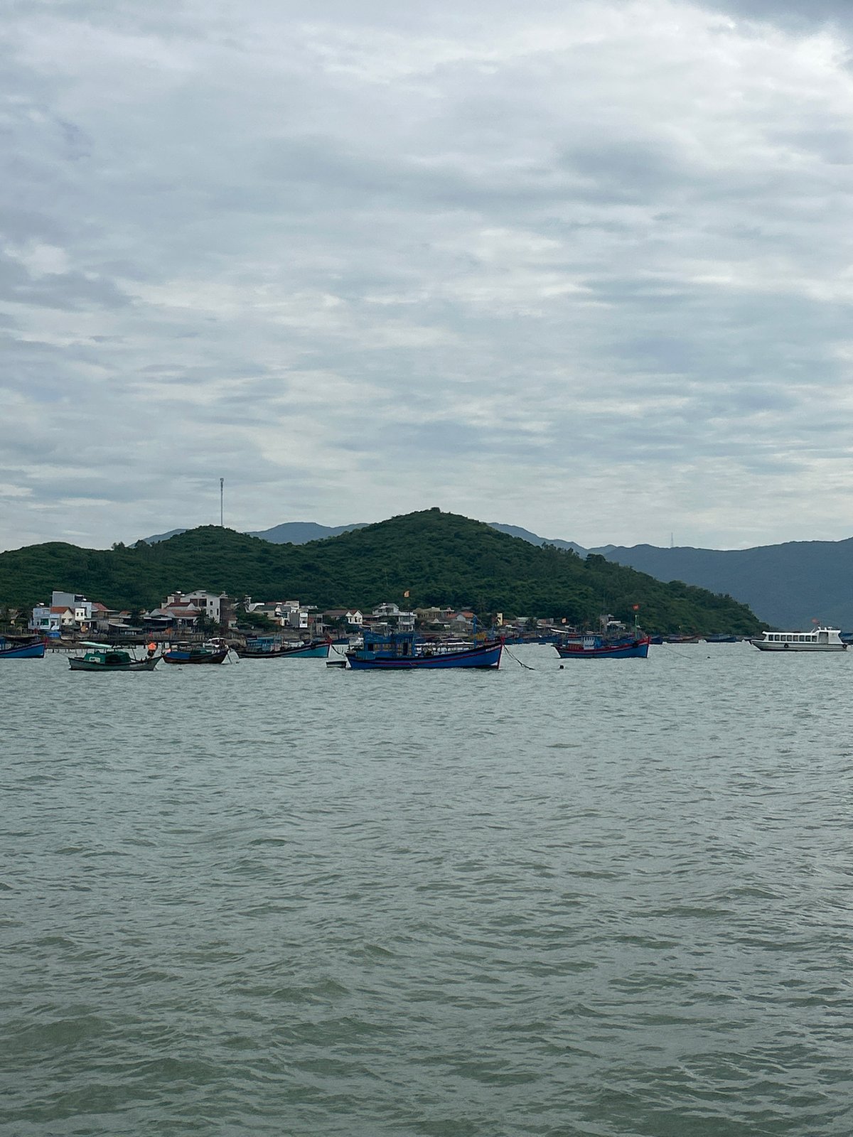 Fishing fleet anchored off the cloudy coast of Ninh Ích